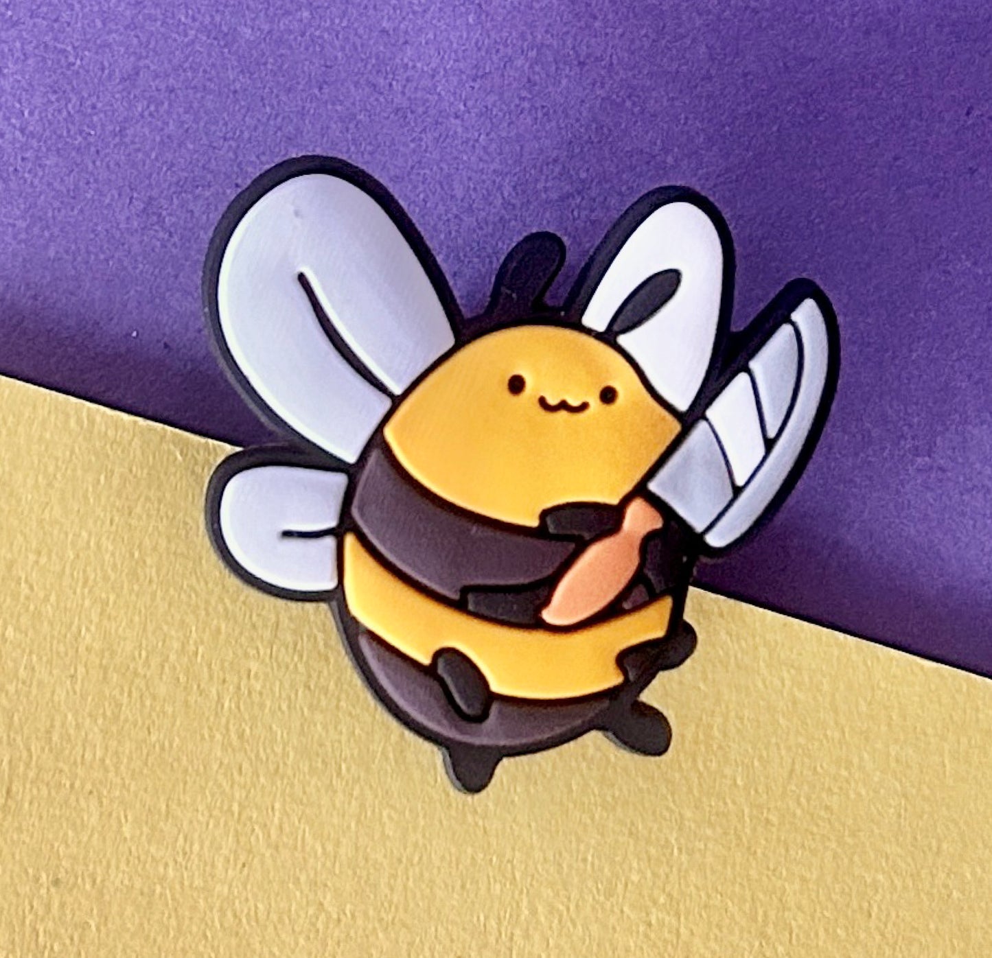 Fat bee holding a knife shoe charm.
