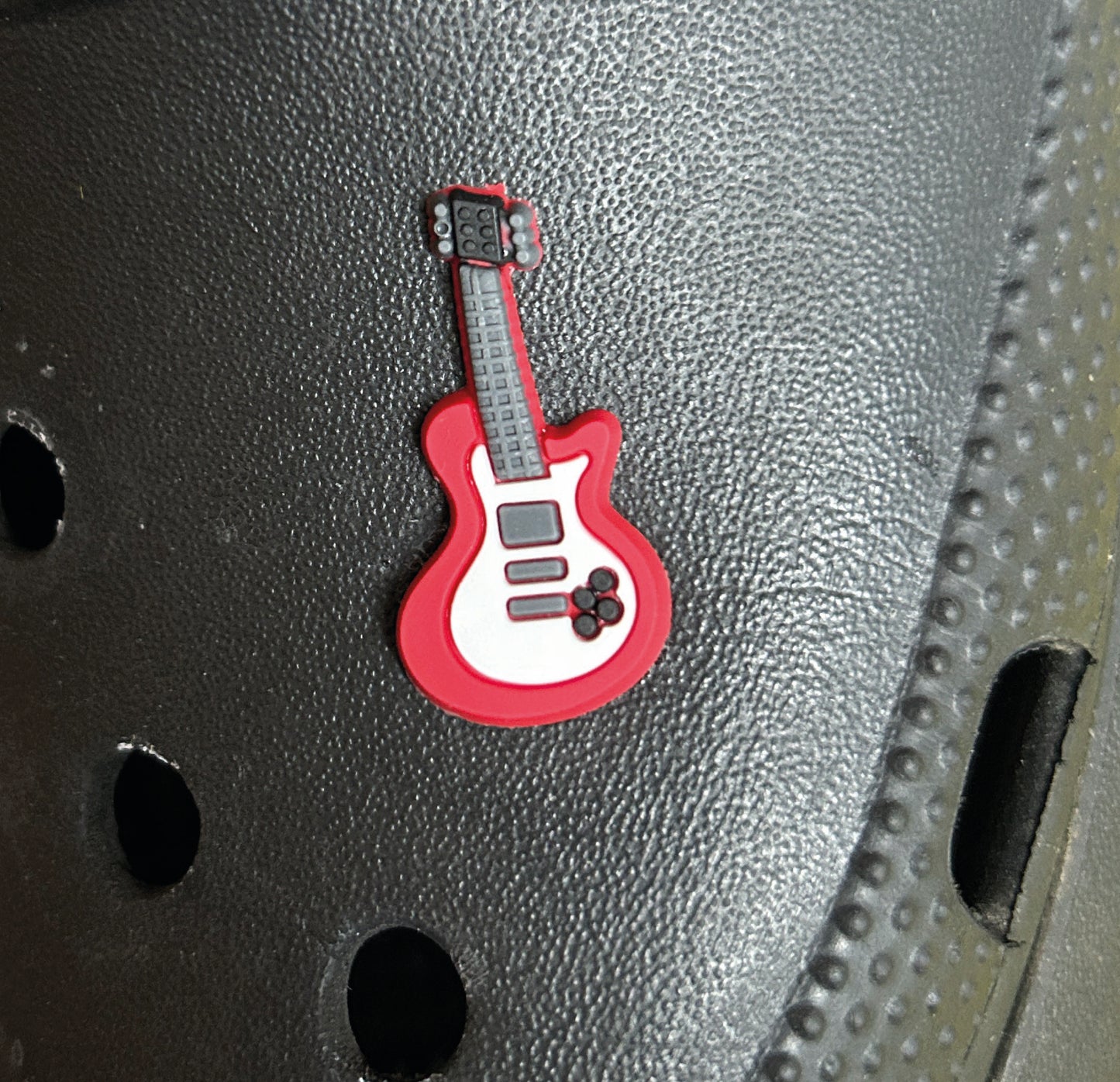 Red electric guitar croc like shoe charm.