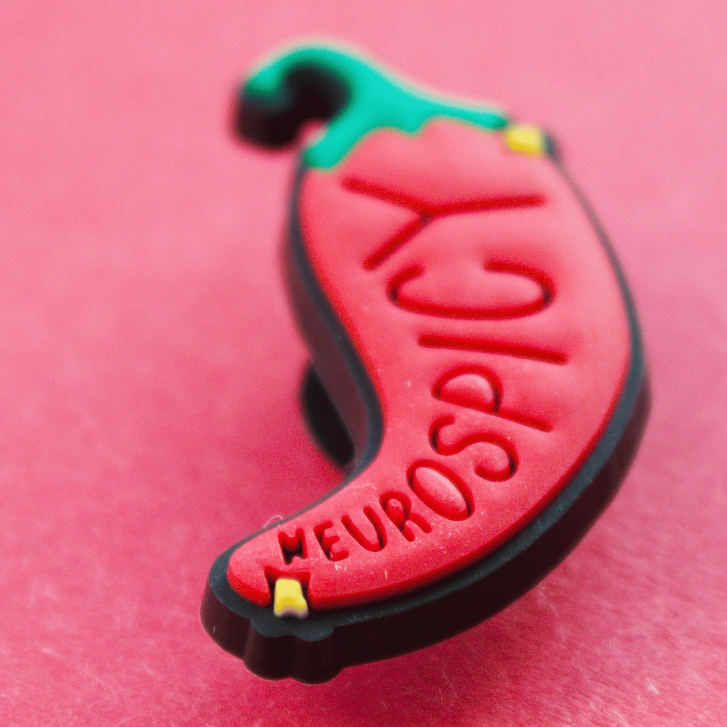 Neurospicy Chilli Pepper croc like shoe charm. Close up image.