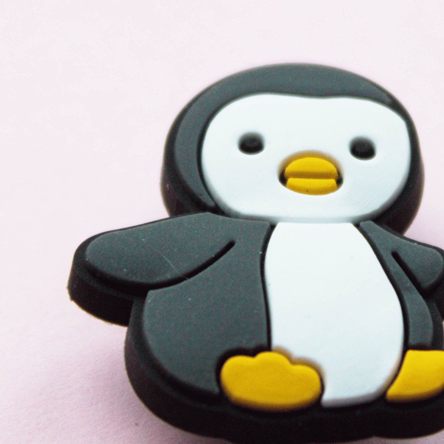 Black and White cute Penguin croc like shoe charm. Close up image.