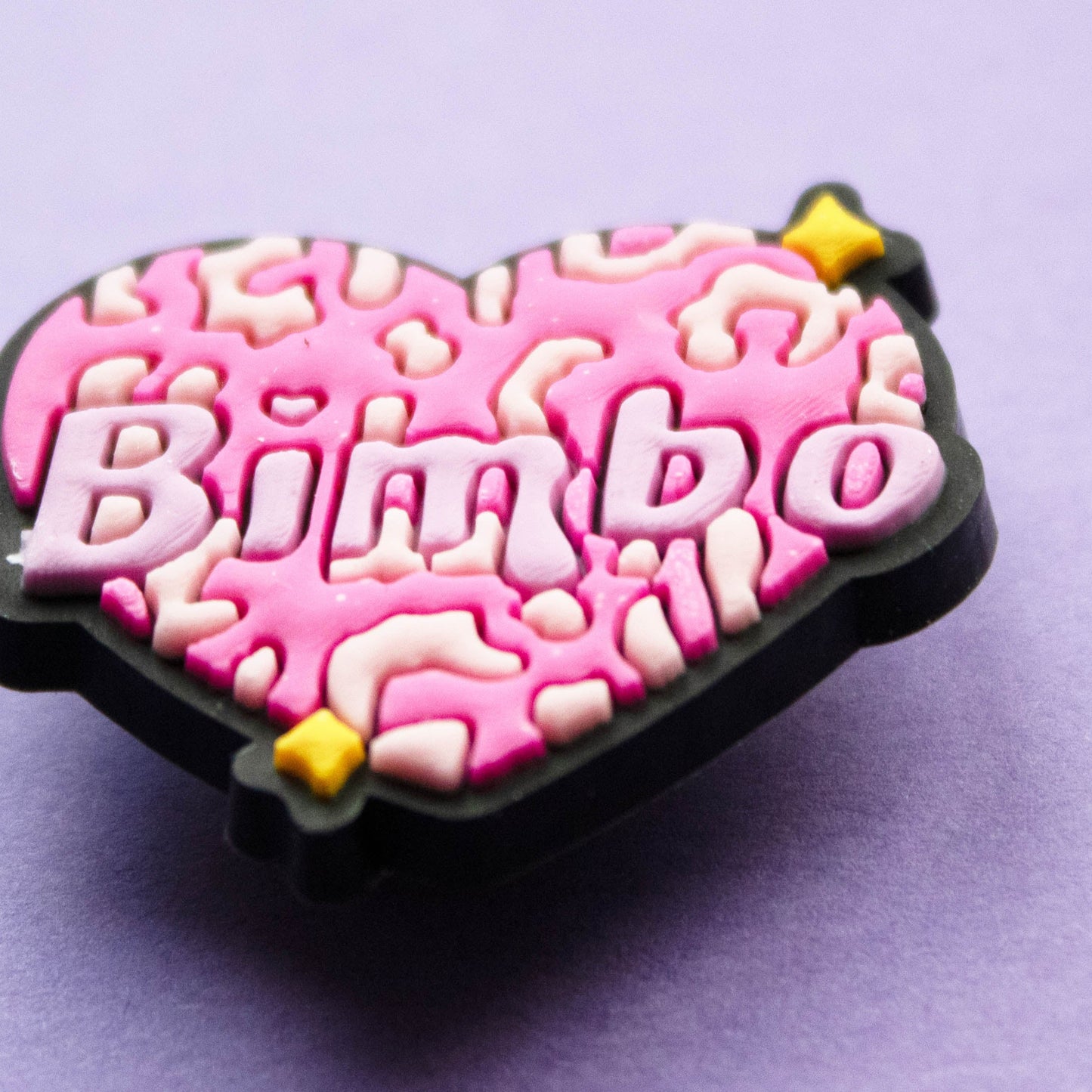 Bimbo word inside a pink leopard print heart. Close up image.