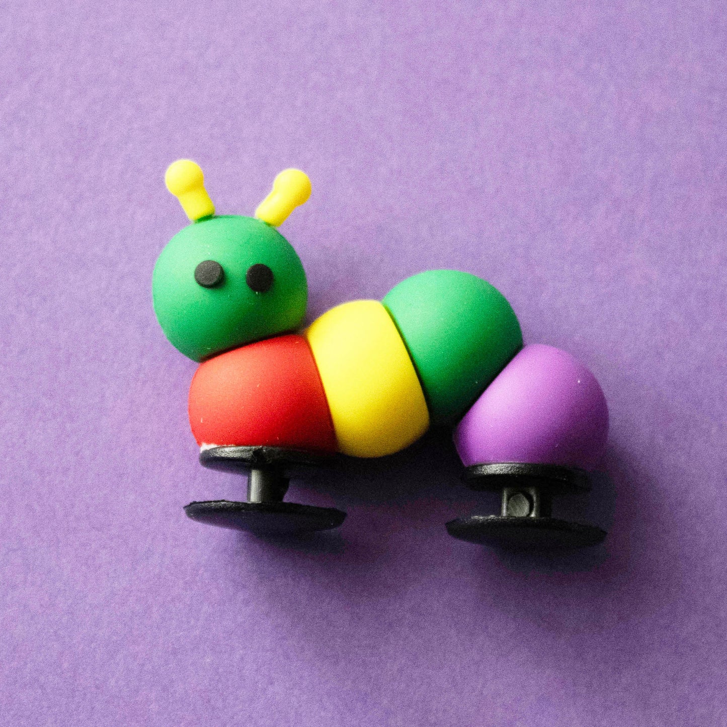 3D Caterpillar croc like shoe charm. Multicoloured.