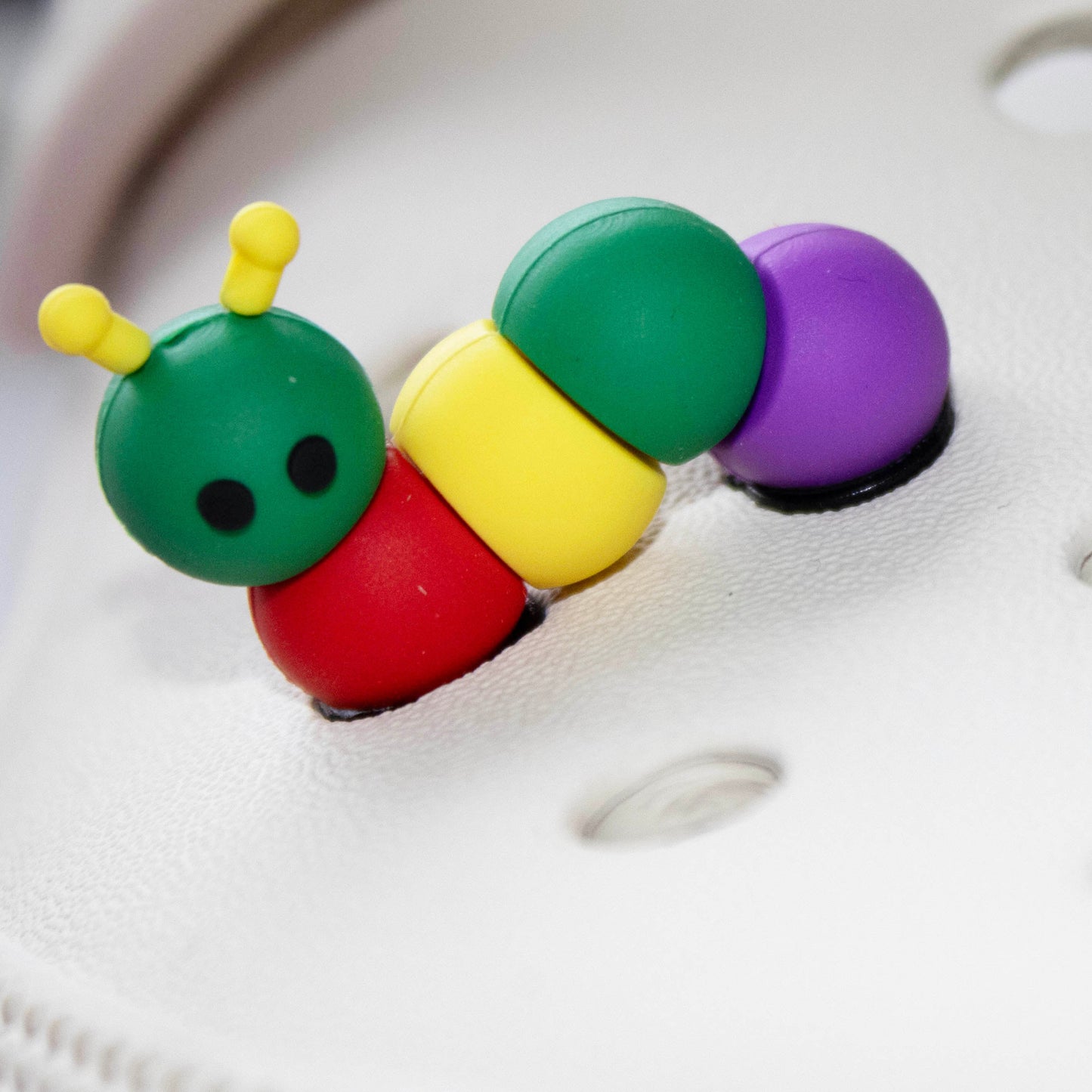 3D Caterpillar croc like shoe charm. Multicoloured. Modelled on a cream croc shoe.