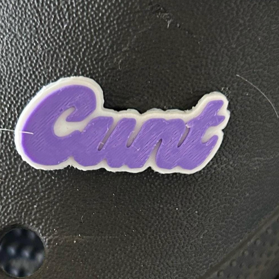 Cunt swear word croc charm.