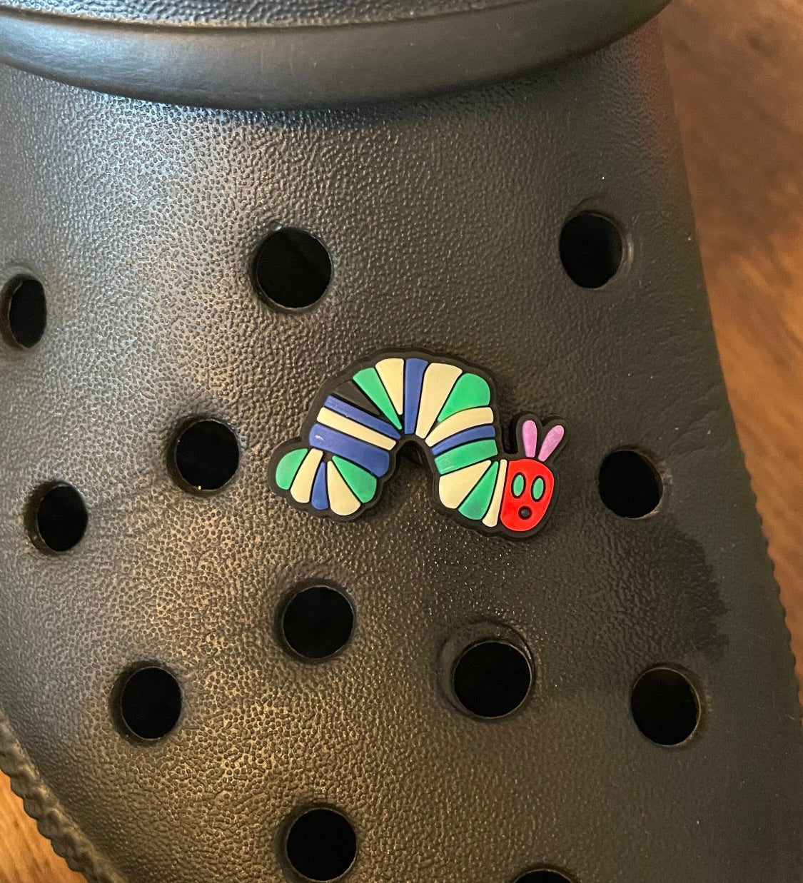 Caterpillar shoe charm on a croc shoe.