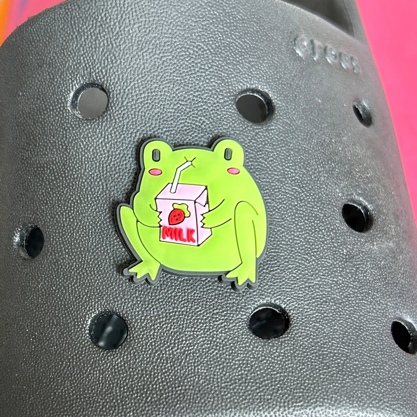 Cute green Frog drinking strawberry milk shoe charm for crocs. Modelled on a black croc sandal.