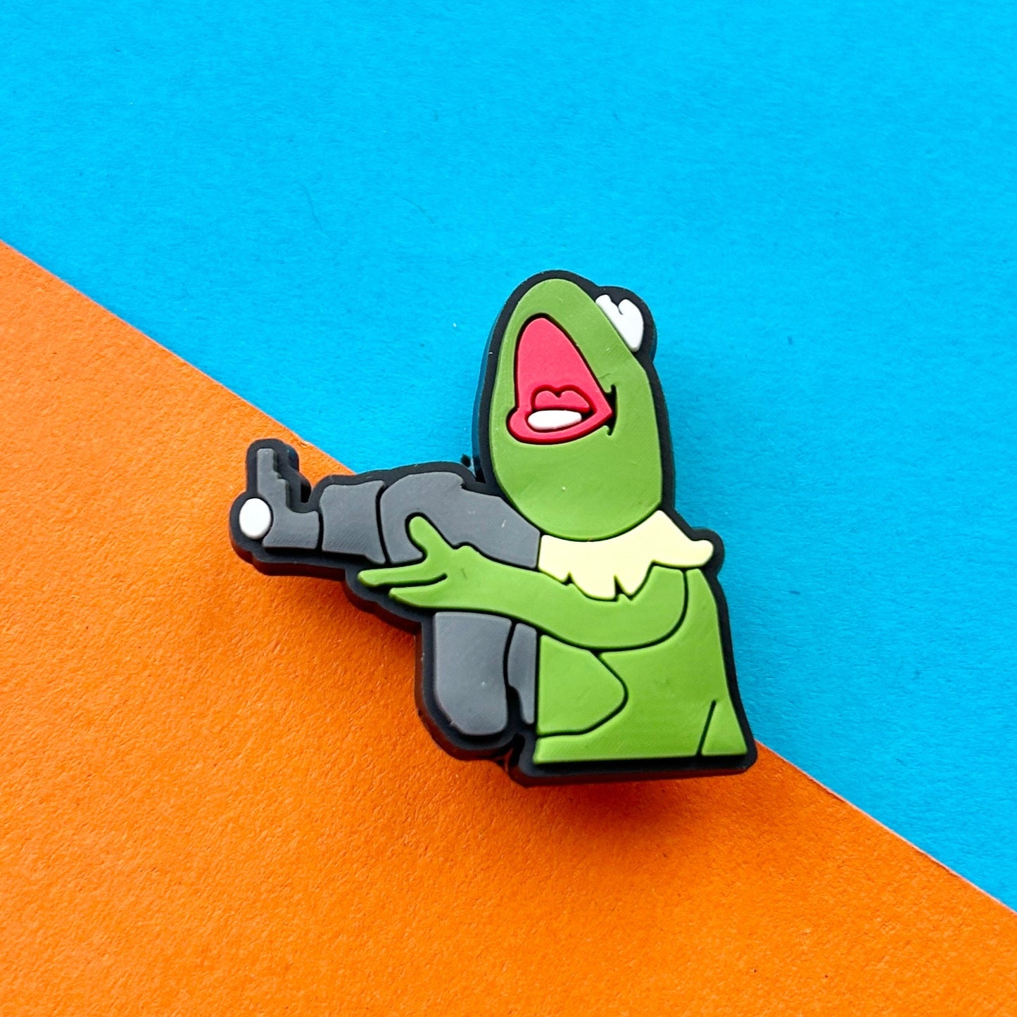 Frog holding a machine gun. Green famous puppet frog.