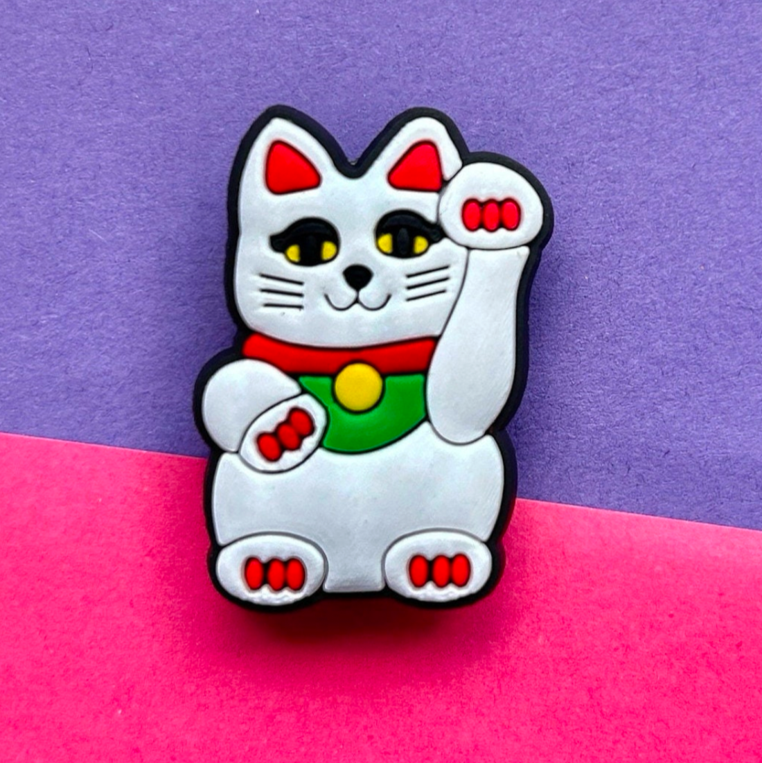 White lucky cat croc like shoe charm.