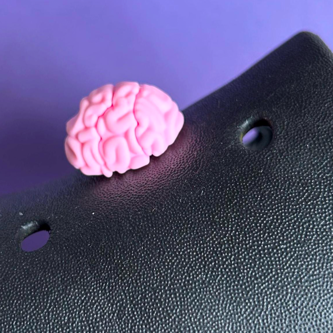 3D Brain croc like shoe charm. Shown on a black croc shoe.