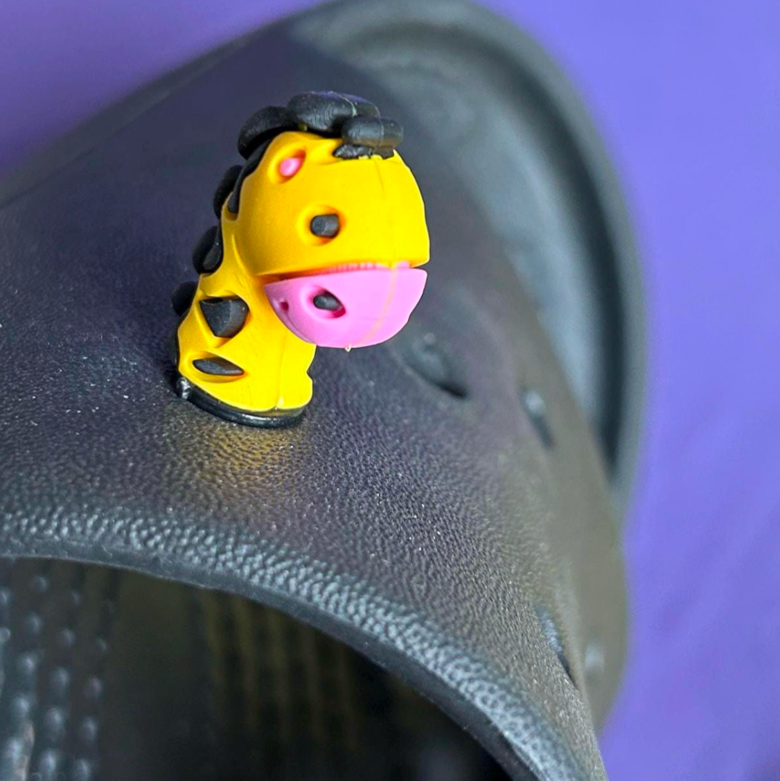 3D Giraffe croc like shoe charm. Shown on a black croc shoe.