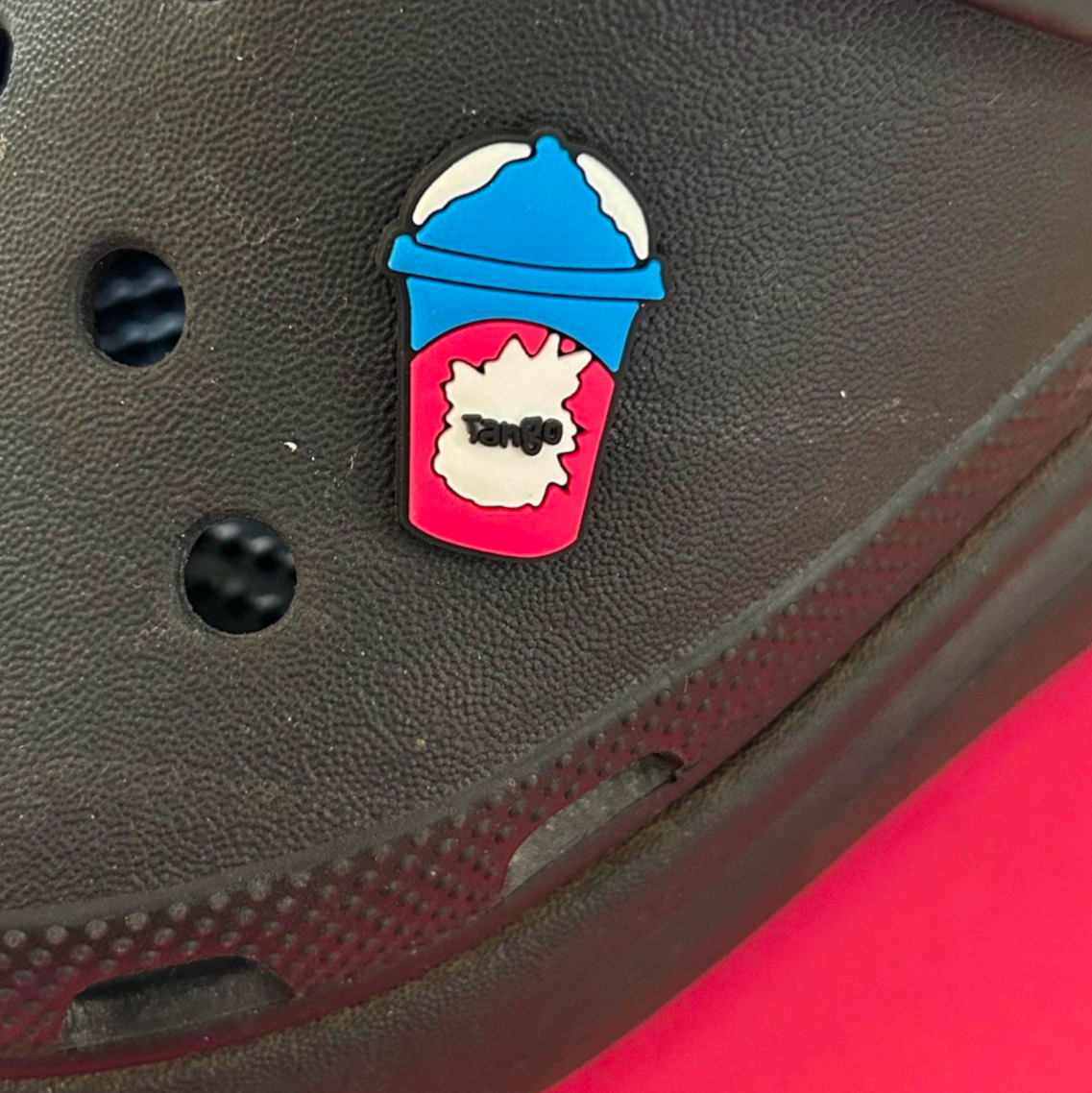 Ice blast cold drink croc like shoe charm. Shown on a black croc shoe.