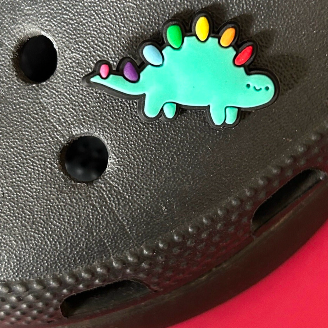 Cute Dinosaur croc like shoe charm. Shown on a black croc shoe.