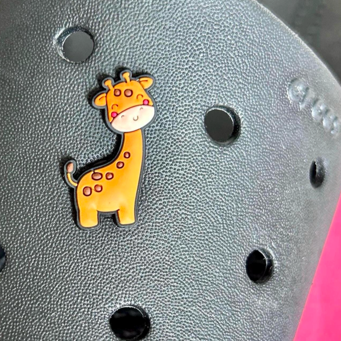 Cute Giraffe croc like shoe charm. Shown on a black croc shoe.