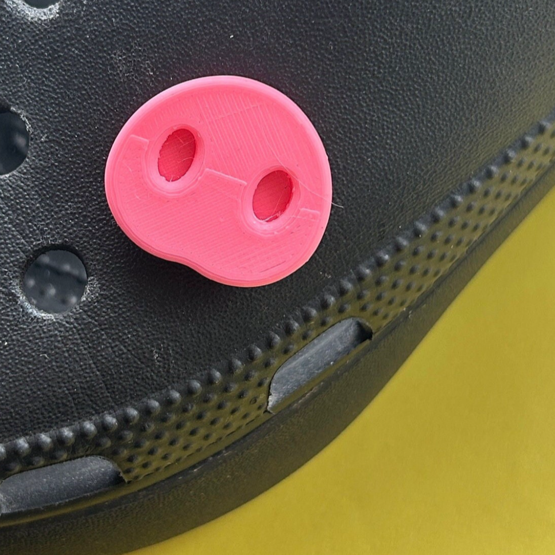 Handmade 3D Printed Pig Snout croc like shoe charm. Shown on a black croc shoe.