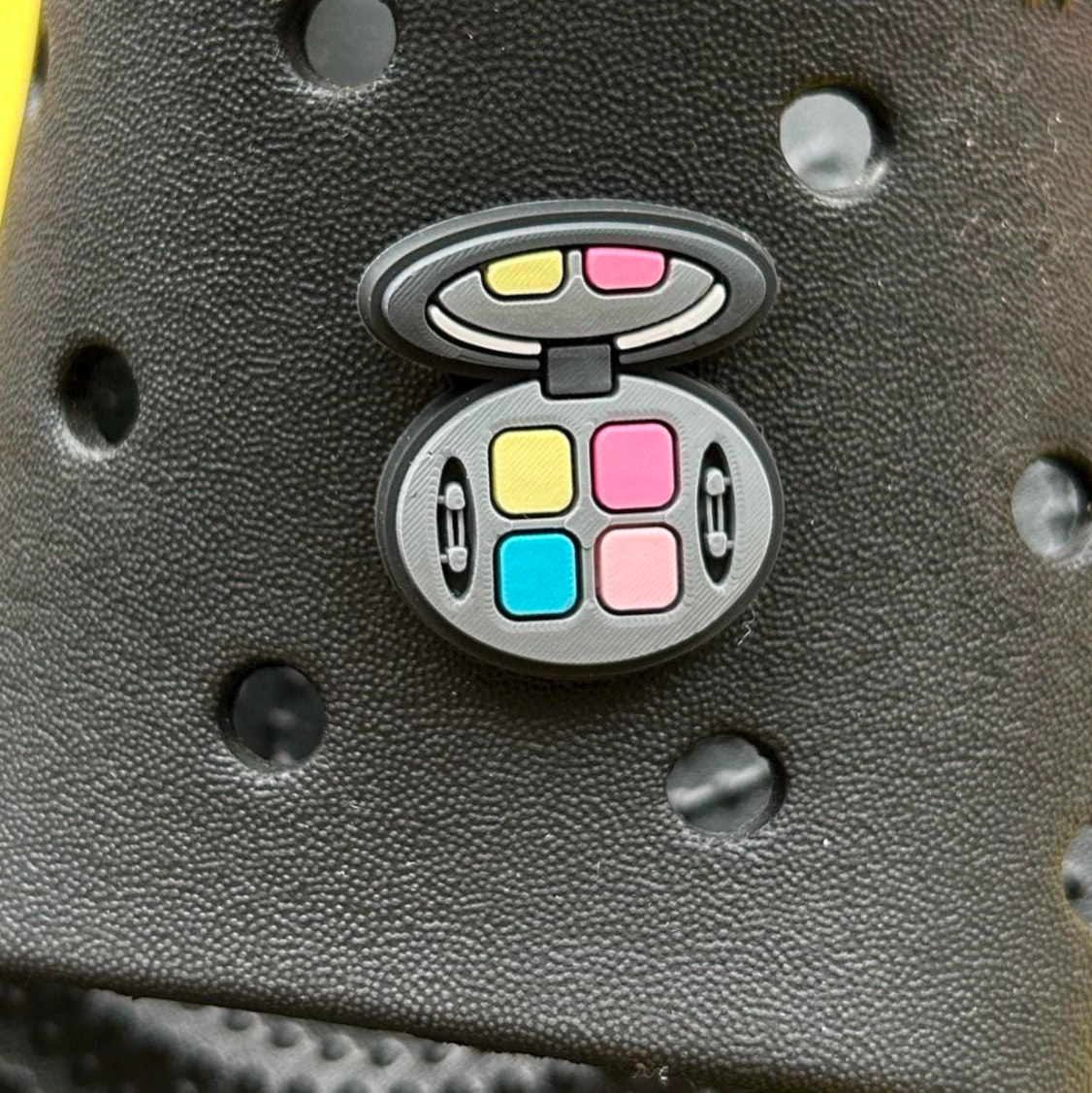 Eyeshadow Compact croc like shoe charm. Shown on a black croc shoe.