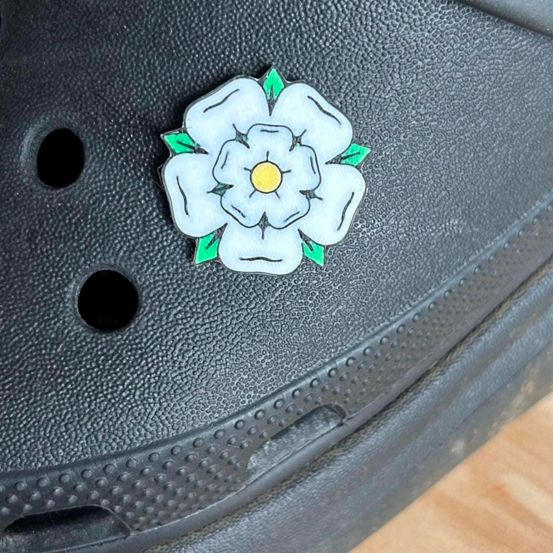 Handmade 3D Printed Yorkshire Rose croc like shoe charm. Shown on a black croc shoe.