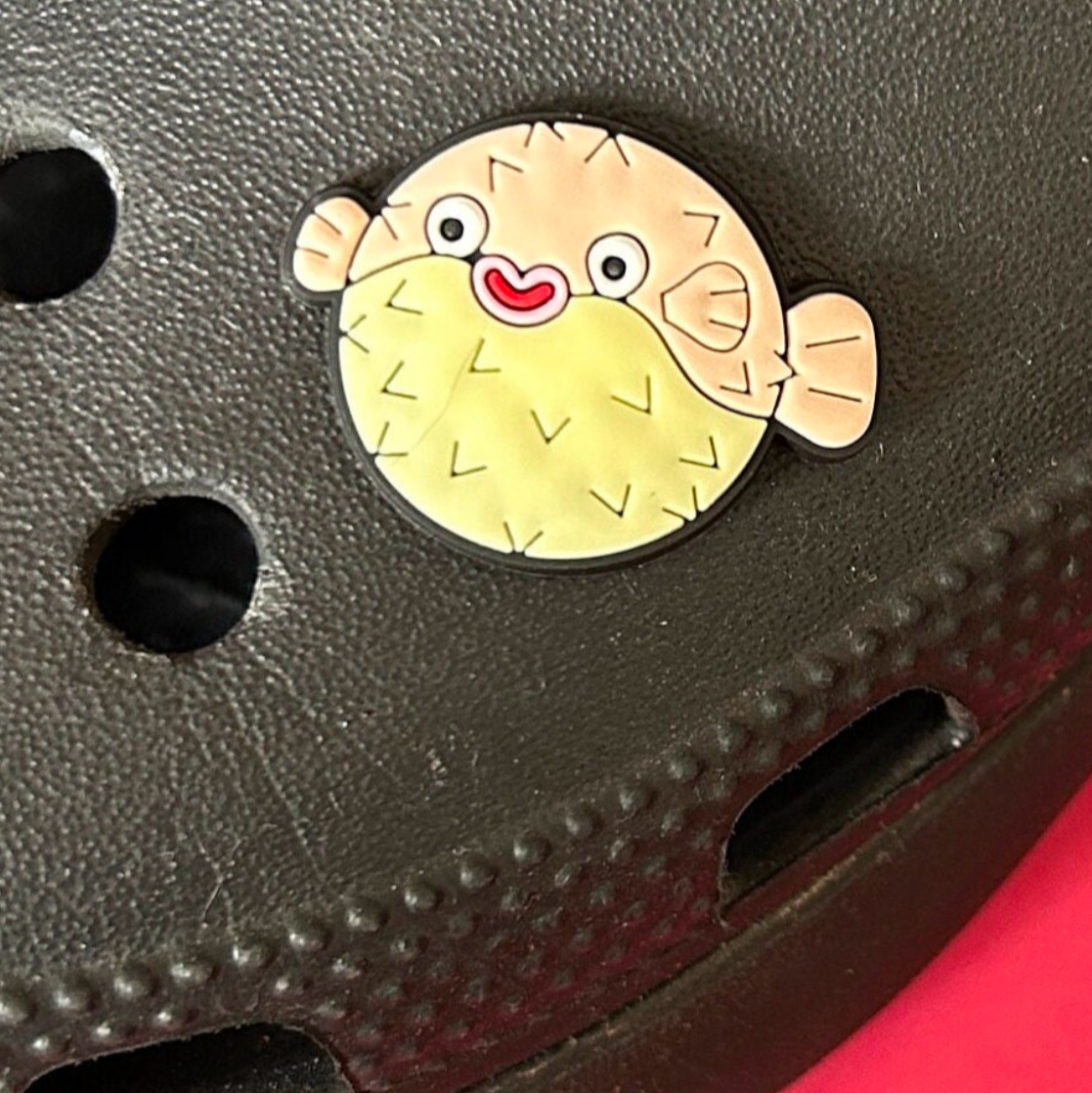 Happy Puffer Fish croc like shoe charm. Shown on a black croc shoe.