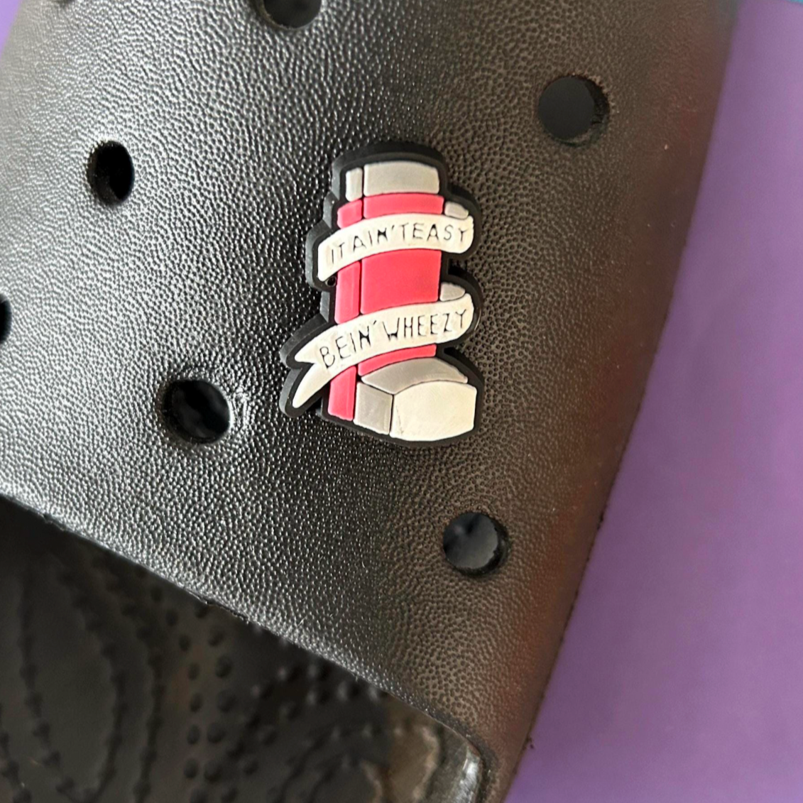 It aint easy being wheezy - Inhaler croc like shoe charm. Shown on a black croc shoe.