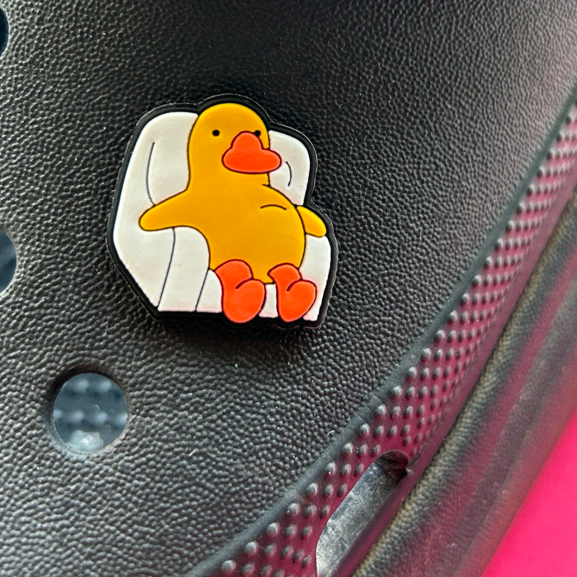 Lazy Chick in a Chair croc like shoe charm. Shown on a black croc shoe.