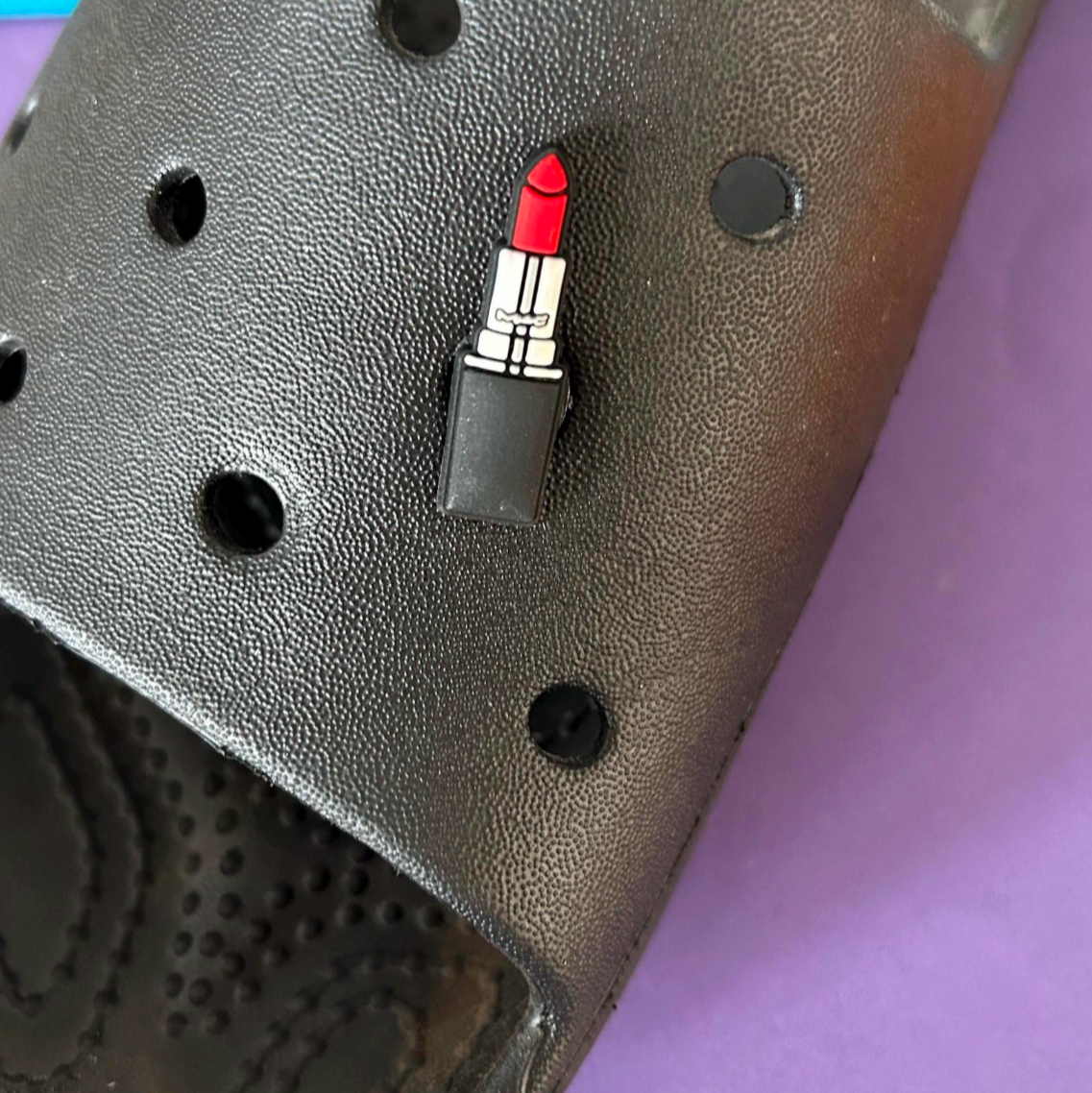 Red Lipstick croc like shoe charm. Shown on a black croc shoe.
