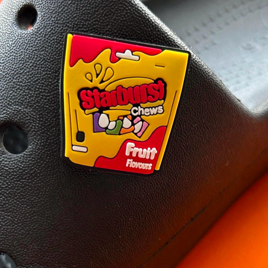 Fruit Chew Sweets croc like shoe charm. Shown on a black croc shoe.