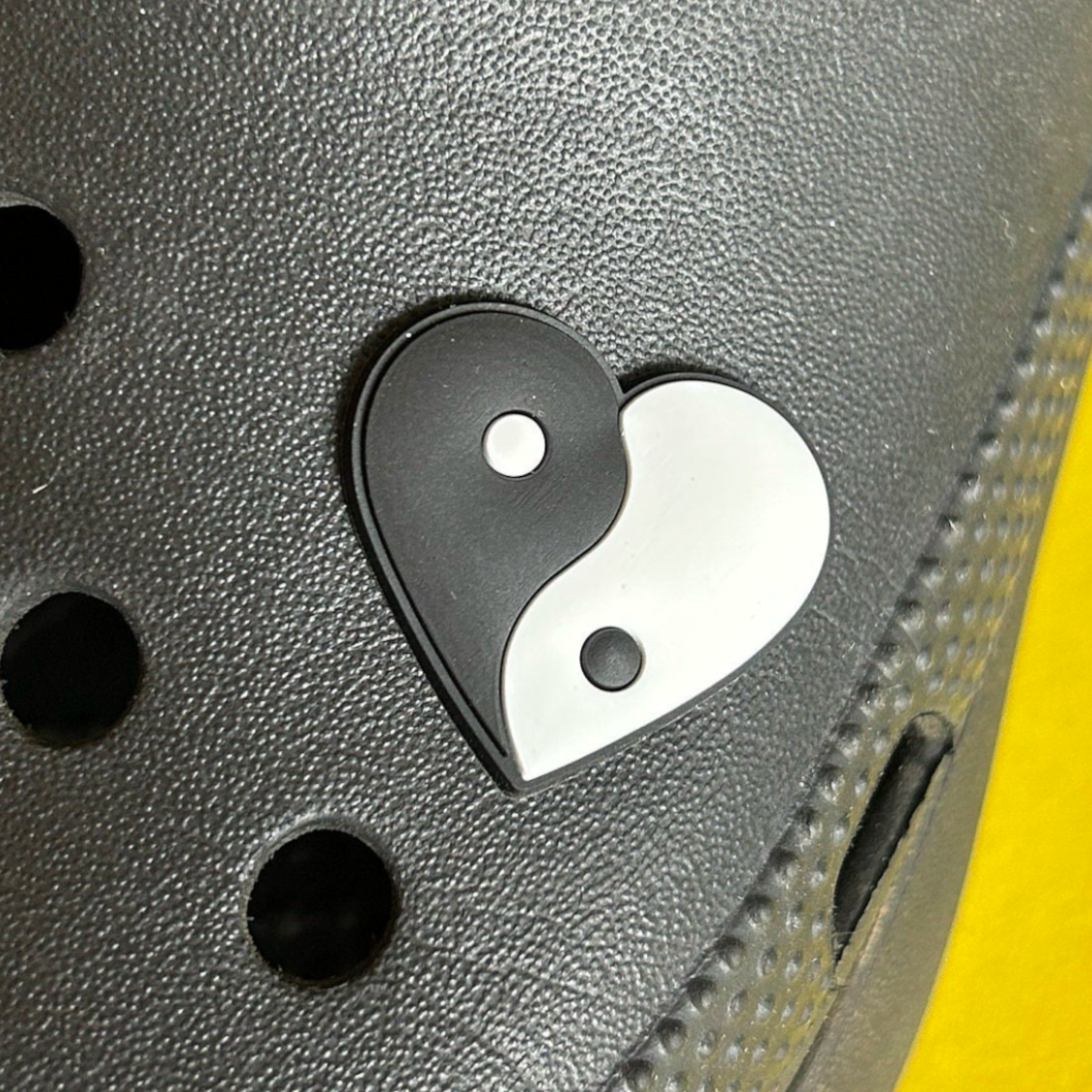 Black and White Yin Yang Heart croc like shoe charm. Shown on a black croc shoe.