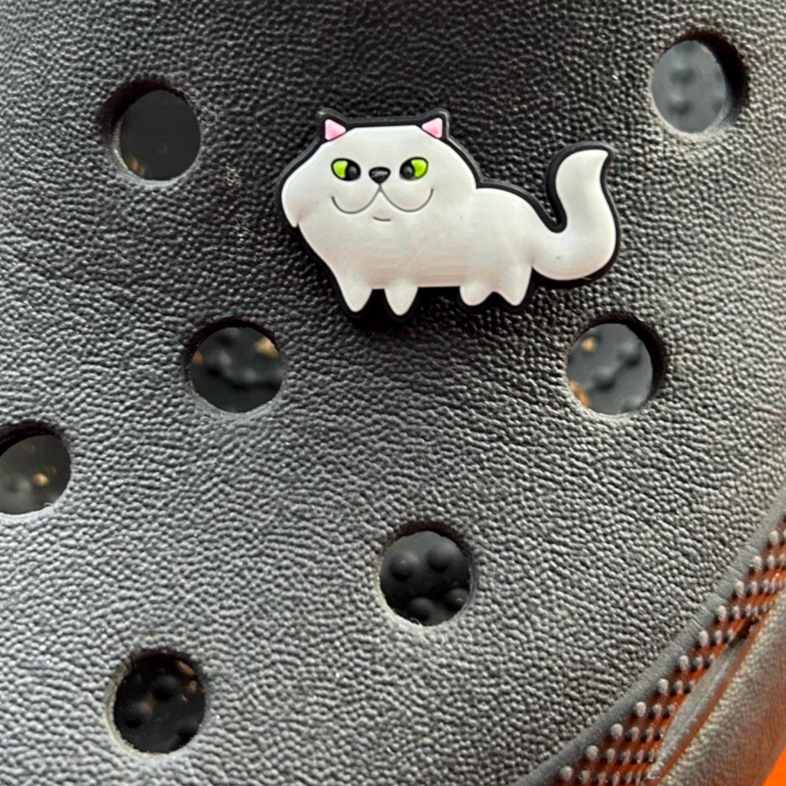 White Cat croc like shoe charm. Shown on a black croc shoe.