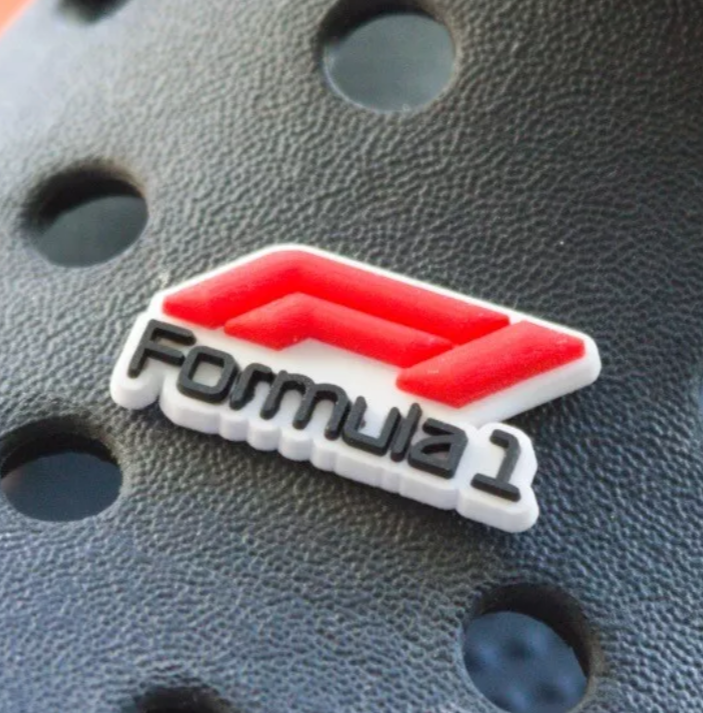 Car Racing croc like shoe charm shown on a black croc shoe.