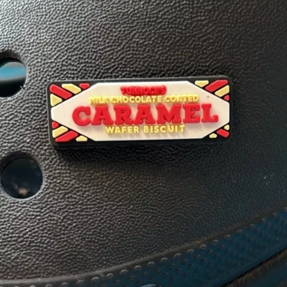 Caramel Biscuit Bar croc like shoe charm. Shown on a black croc shoe.