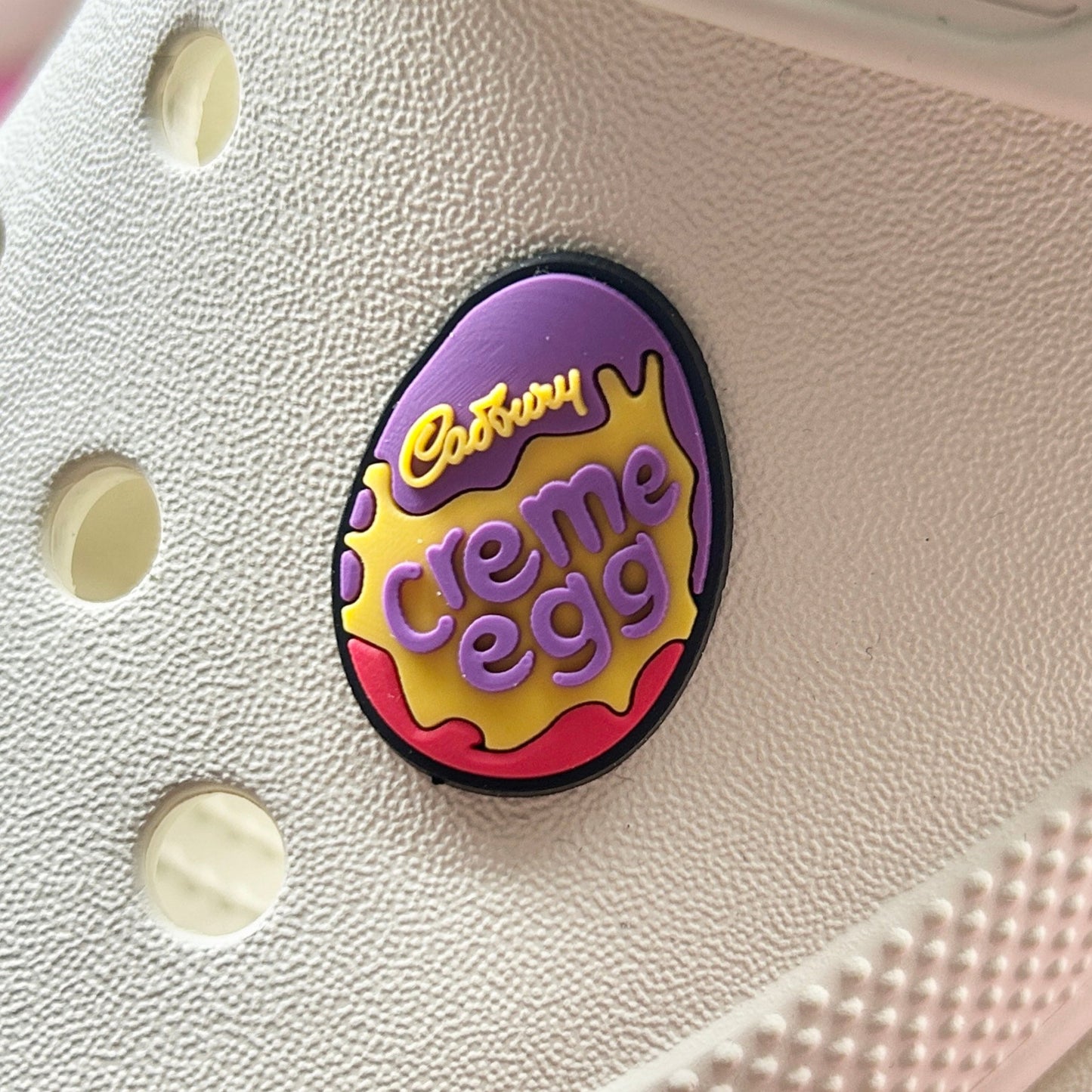 Chocolate egg with creme croc like shoe charm. Shown on a cream croc shoe.