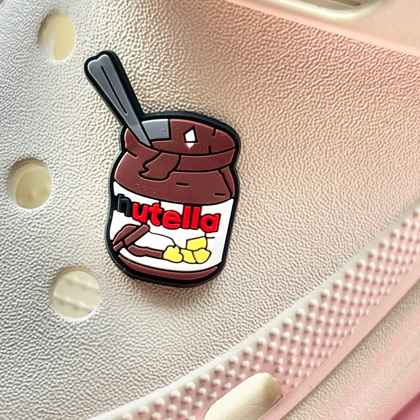 Nutty Chocolate Spread croc like shoe charm. Shown on a cream croc shoe.