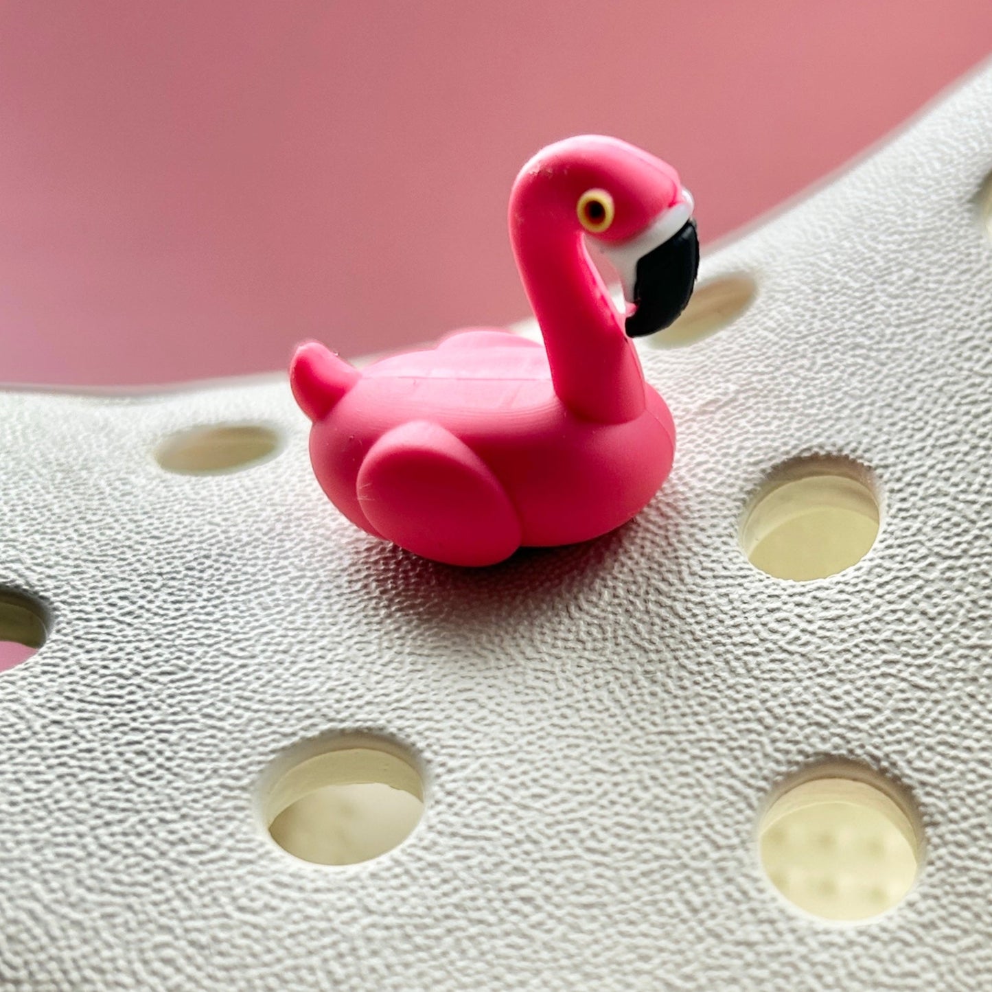 3D Flamingo bird croc like shoe charm. Shown on a cream croc shoe.