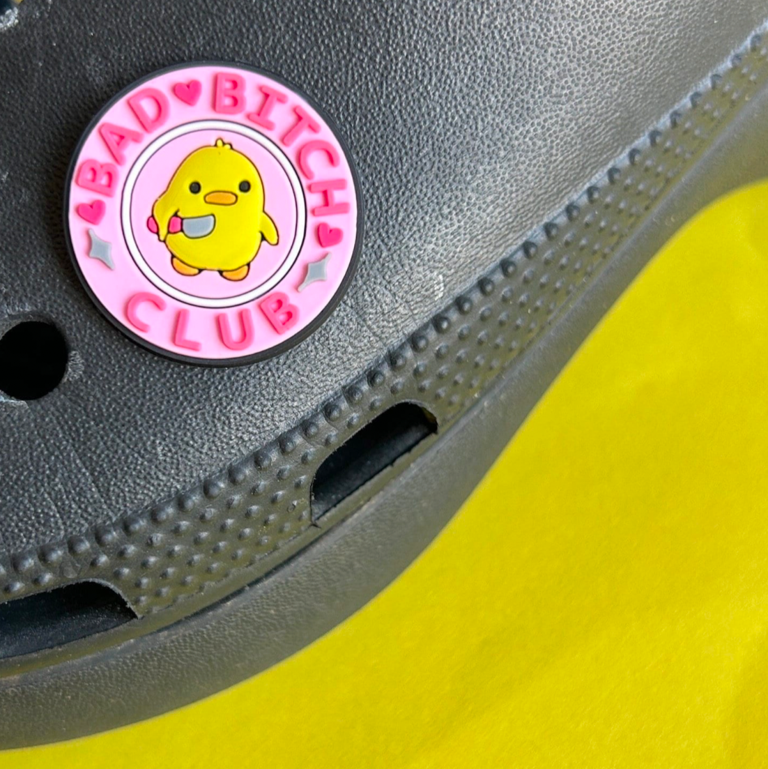 Bad Bitch Club slogan croc like shoe charm. Shown on a black croc shoe.