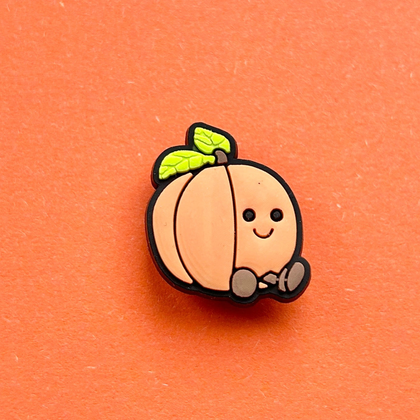 Peach croc like shoe charm.