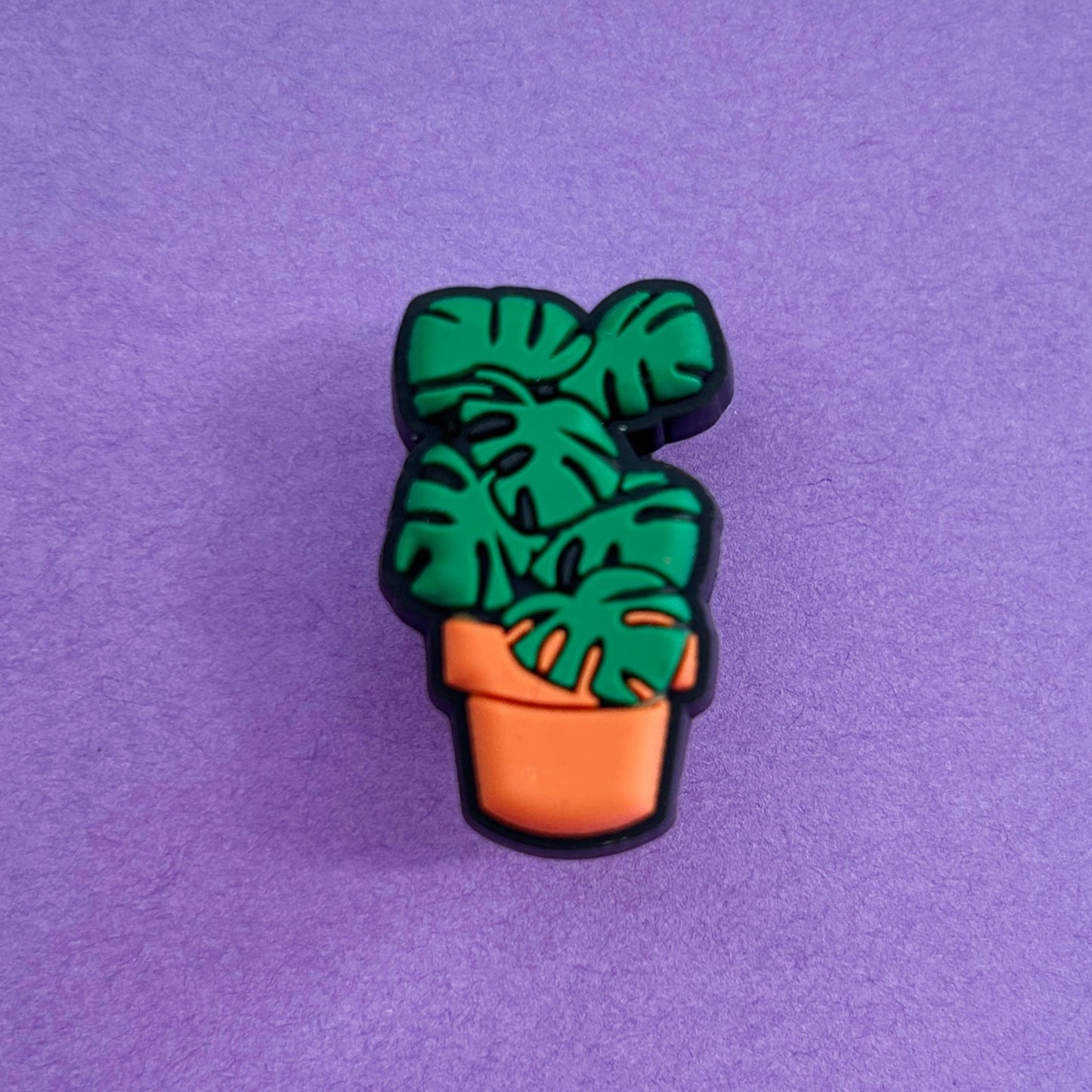 Monstera plant Croc shoe charm. Green plant in an orange pot.