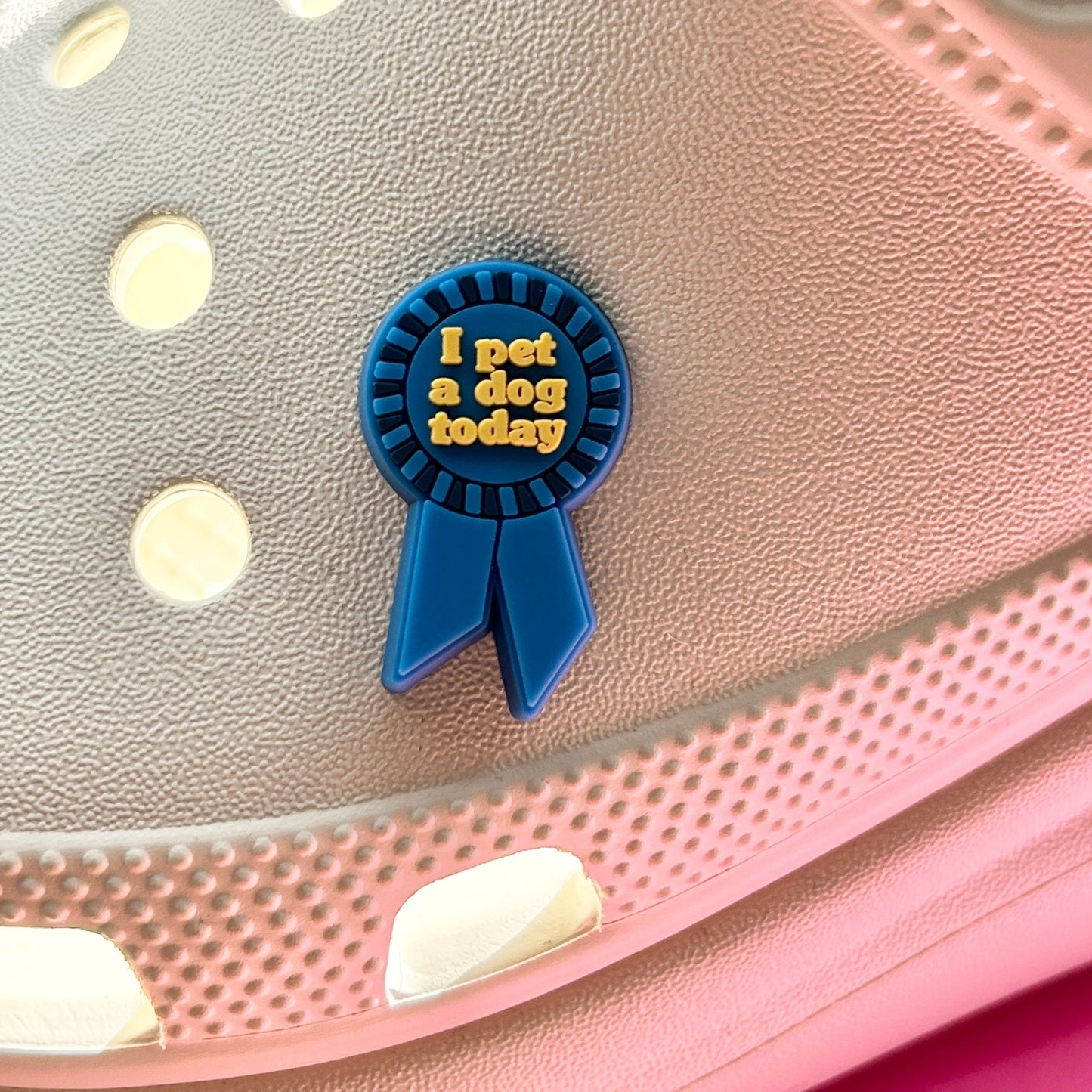 I Pet A Dog today award shoe charm. Shown on a cream croc shoe.