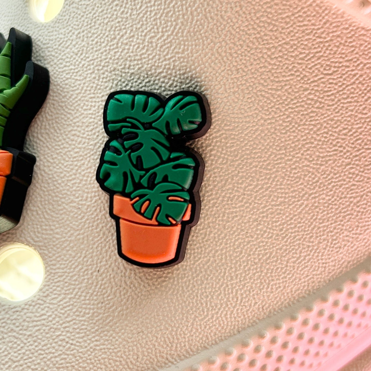 Monstera plant Croc shoe charm. Shown on a cream croc shoe.