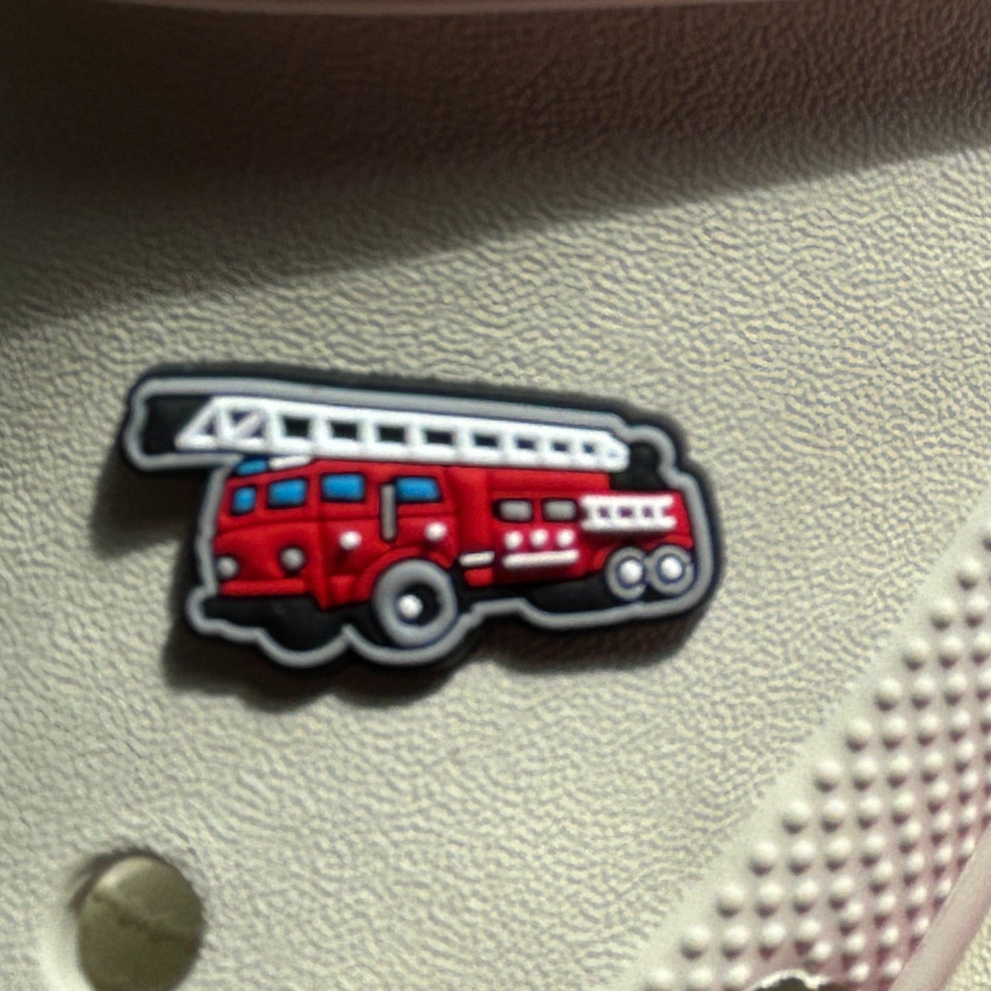 Red Fire engine croc shoe charm. Shown on a cream croc shoe.
