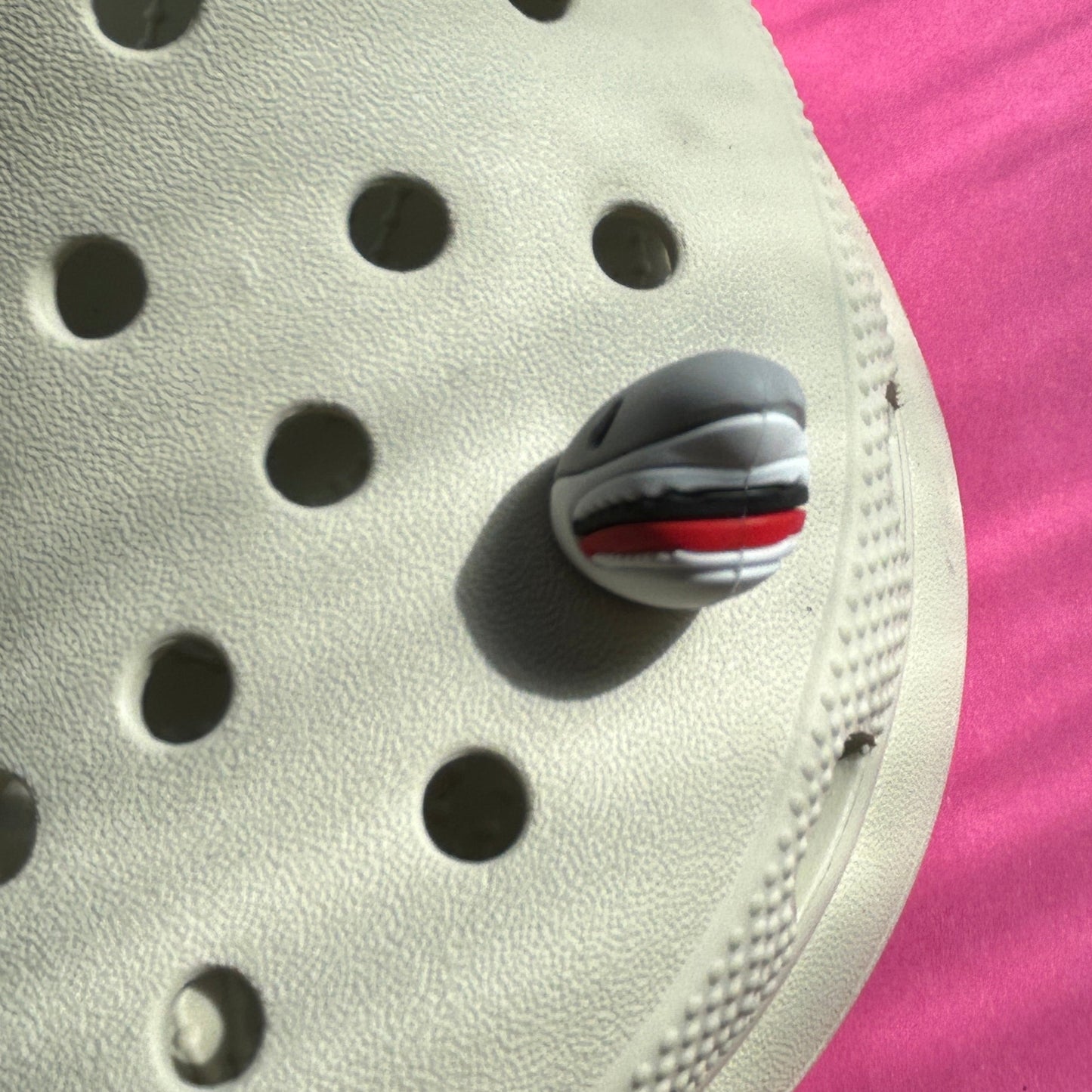 Great white shark 3D rubber croc charm. Modelled from the front on a cream croc shoe.