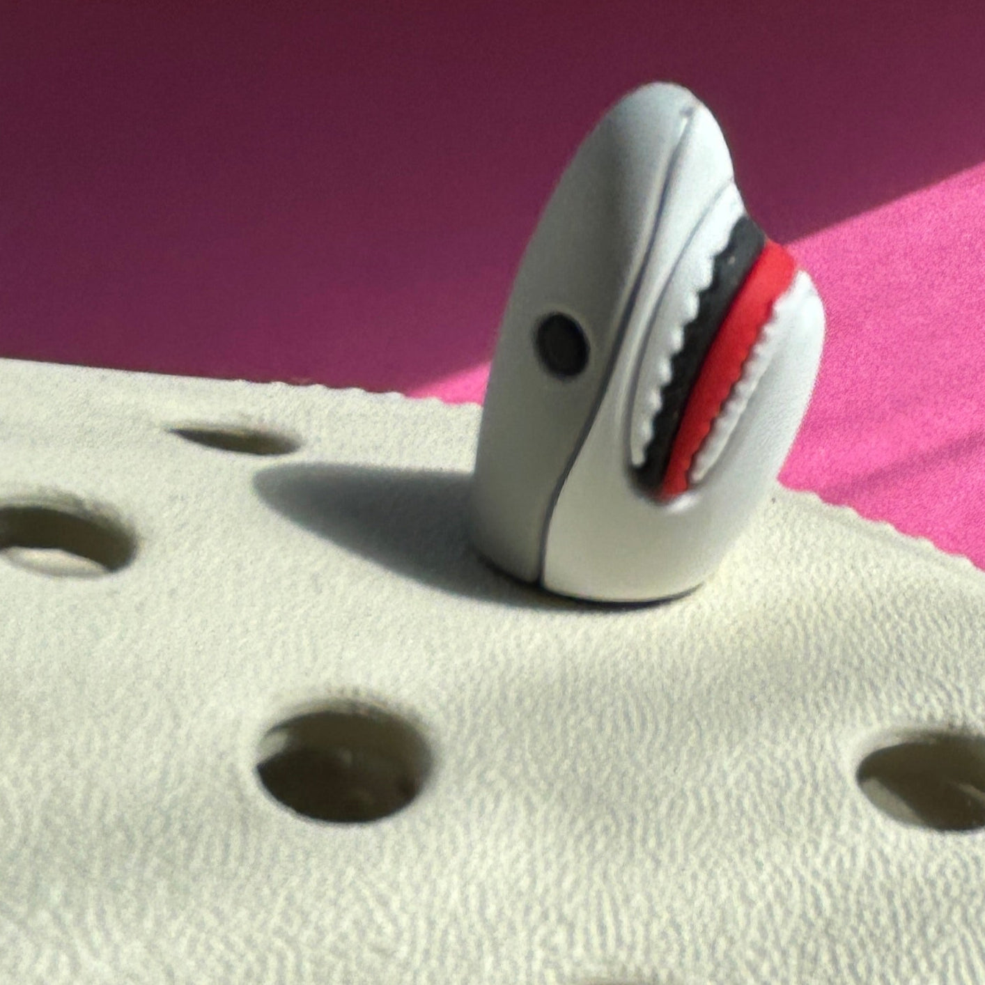 Great white shark 3D rubber croc charm. Modelled on a cream croc shoe. Side view.