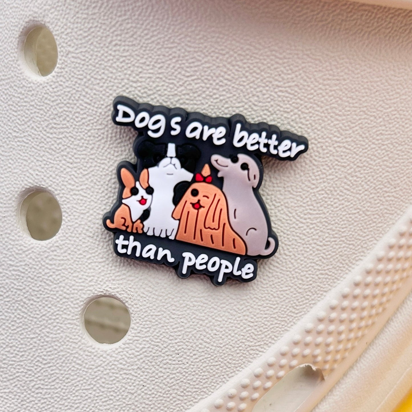 Dogs are better than people shoe charm. Group of four different dog types. Shown on a cream croc shoe.