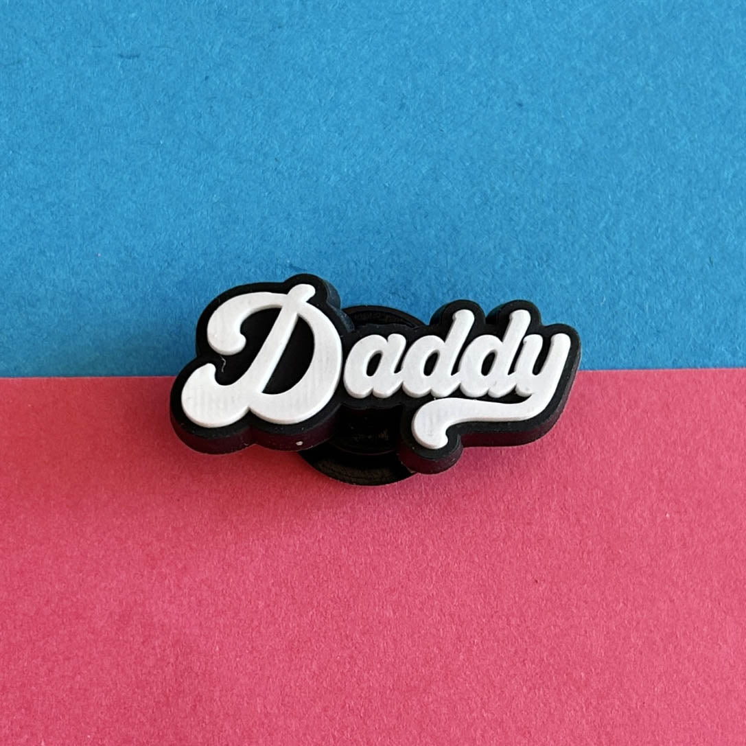 Daddy writing croc like shoe charm accessory.