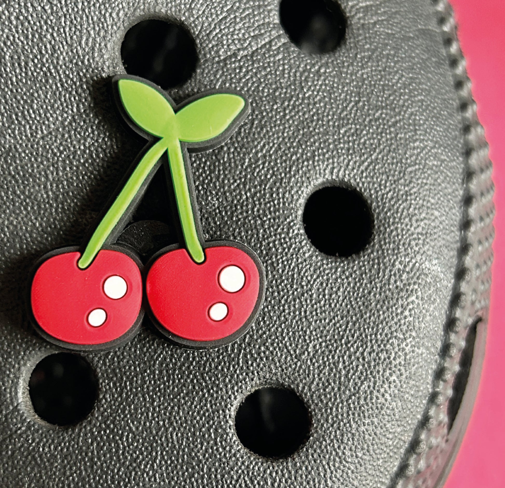 Cherry shoe charm on a croc shoe.