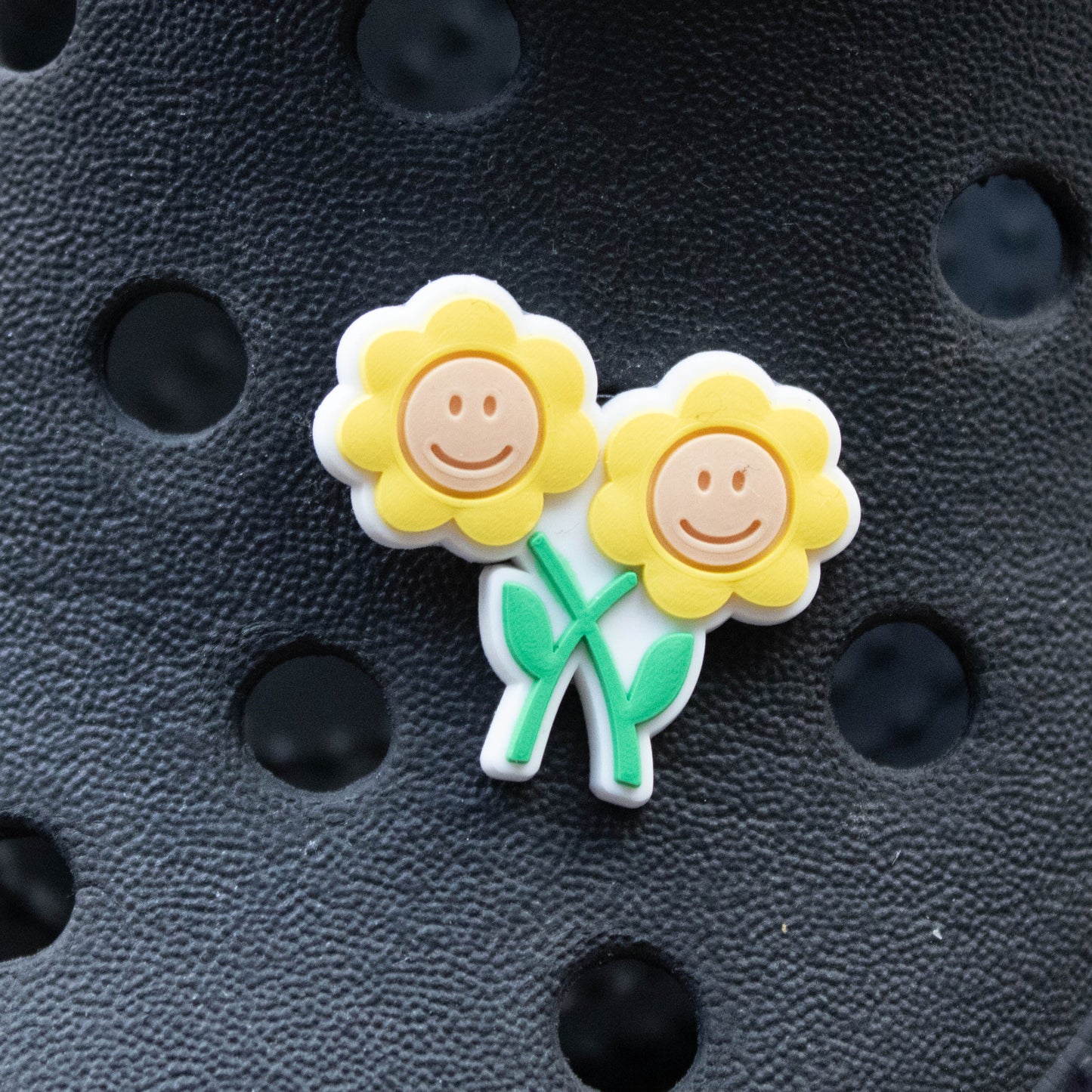 Yellow two smiley Flowers croc like shoe charm. Shown on a black croc shoe. 