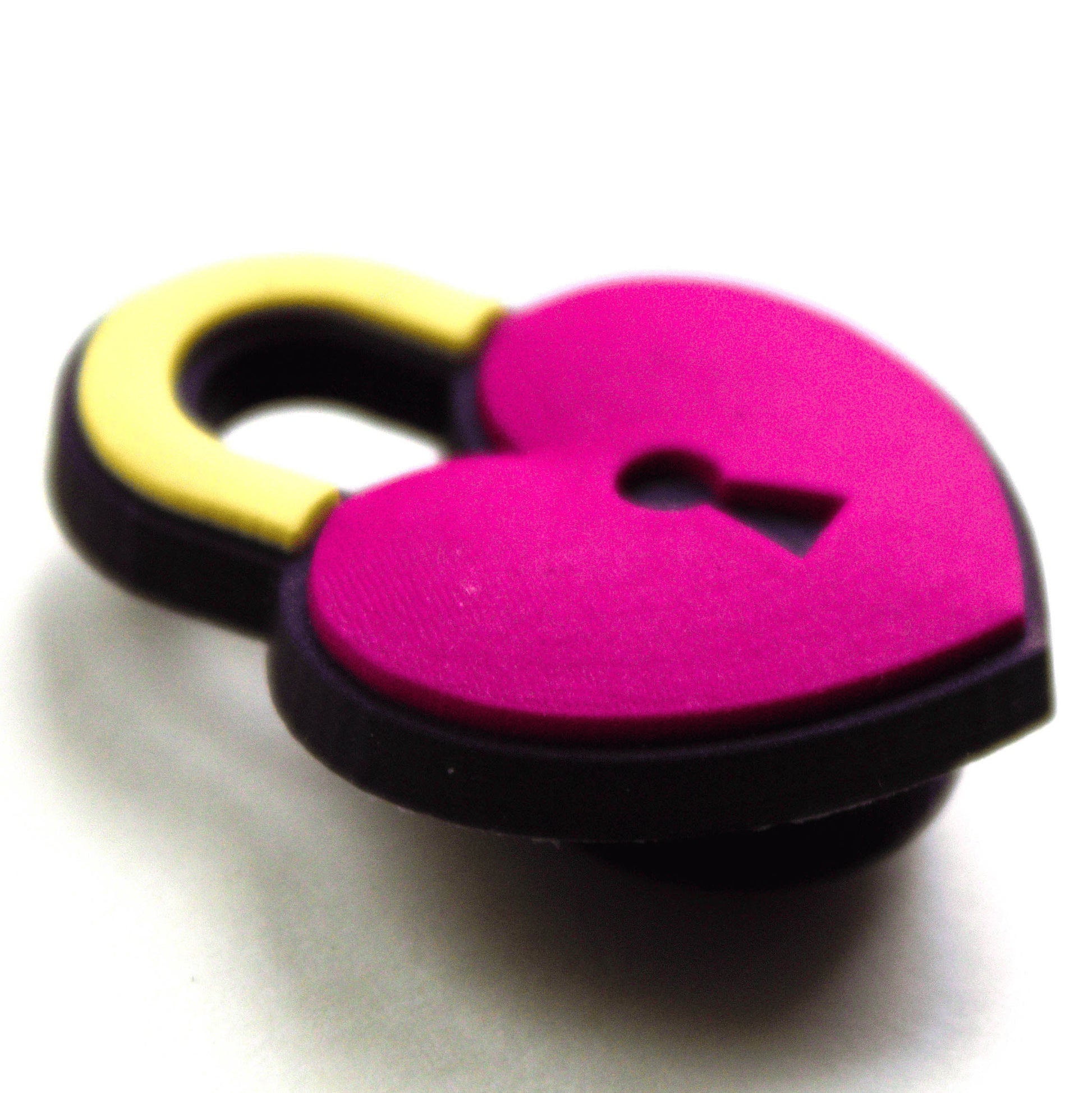 Heart Padlock croc like shoe charm. Pinky red and yellow. Close up image.