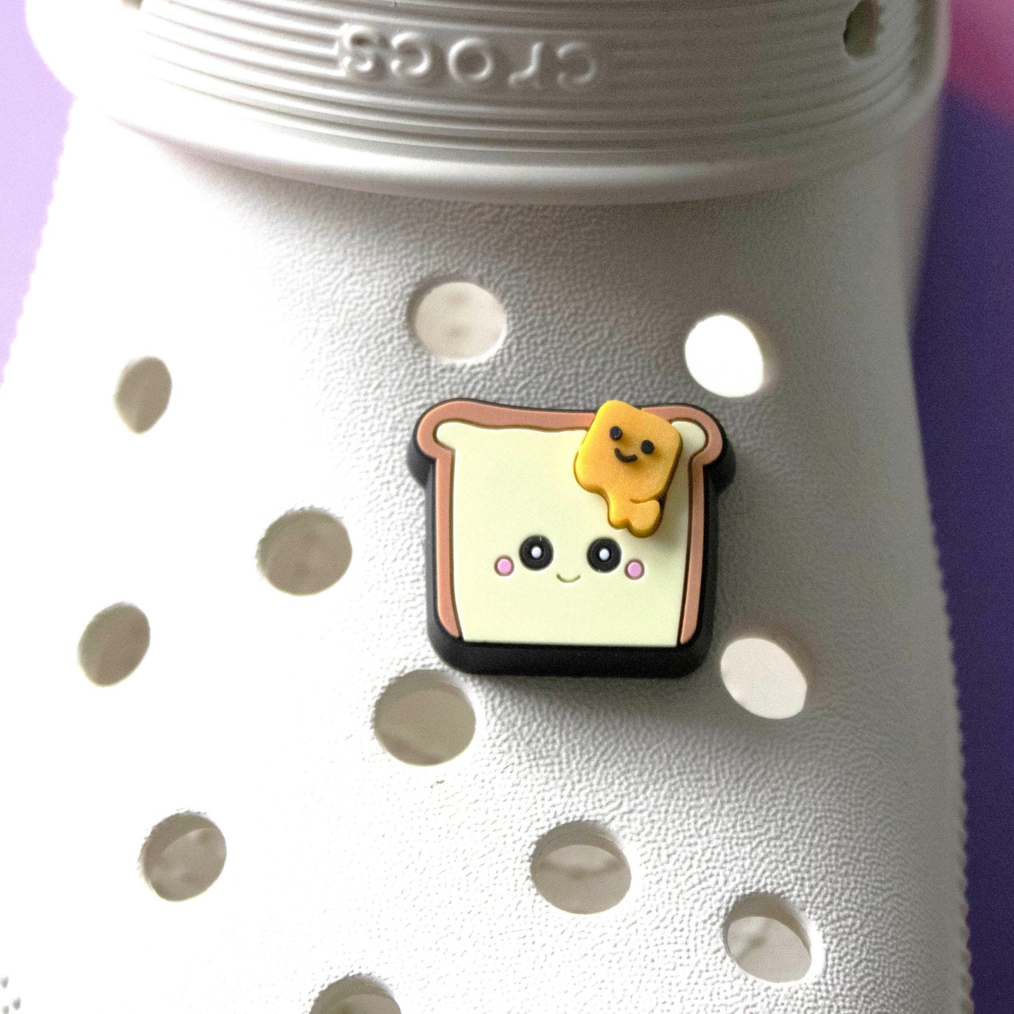 Toast and Butter Premium croc charm. Shown on a cream croc shoe. 