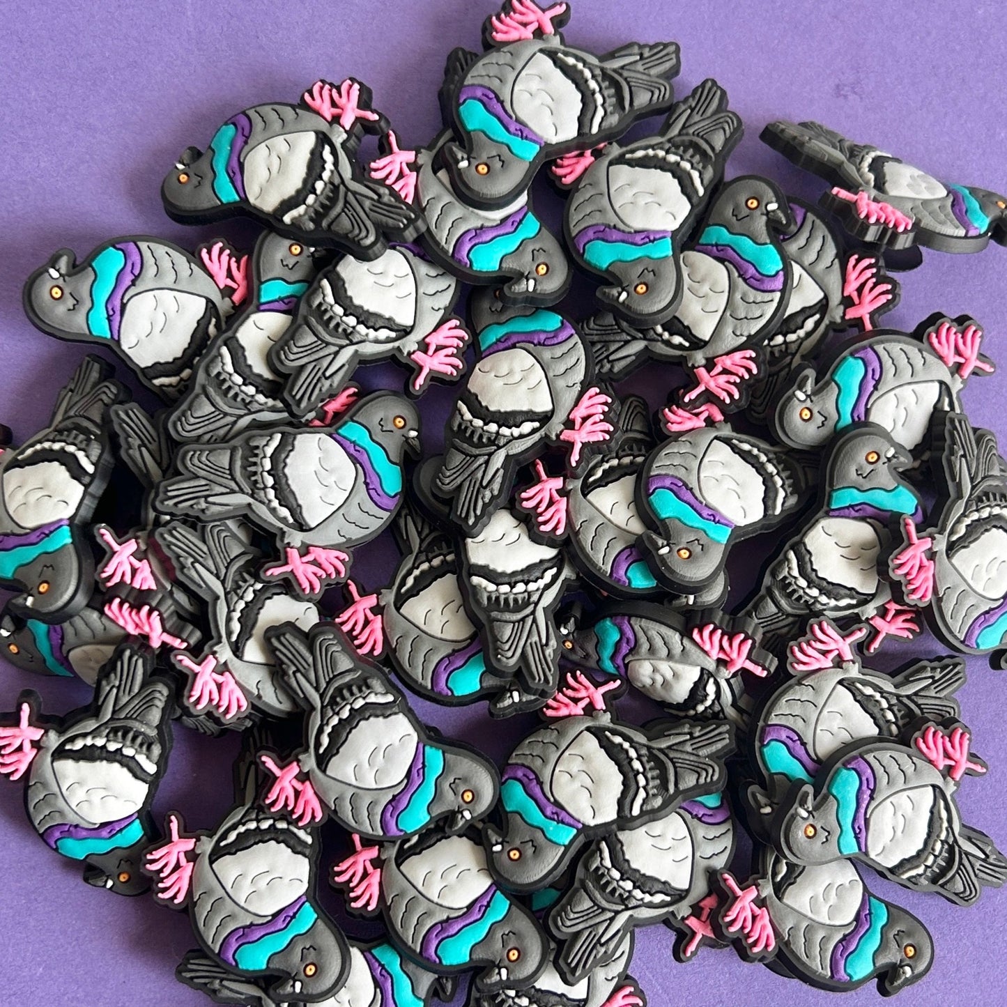 A pile of pigeon croc charms.