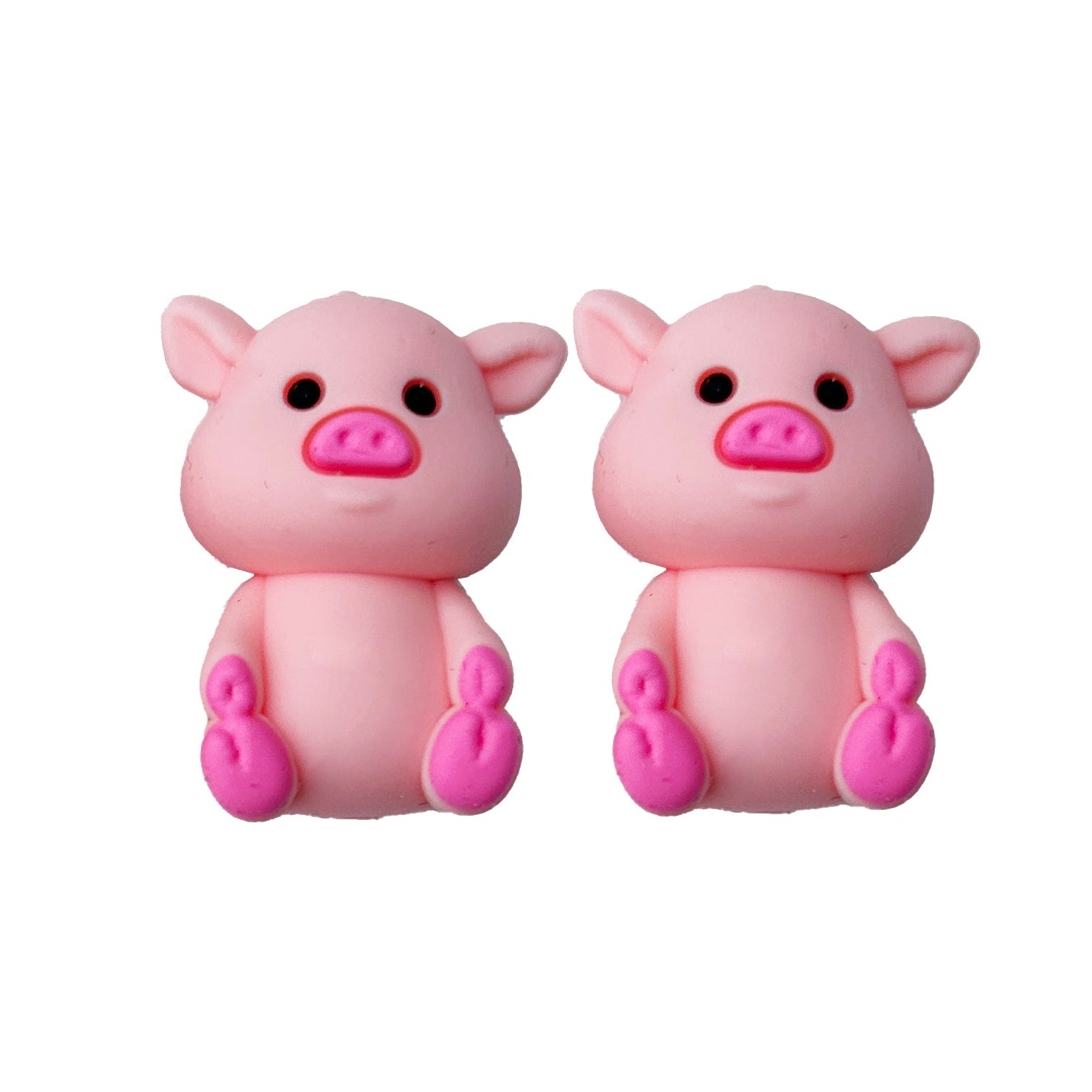 Two pink pig needle point protectors on a white background