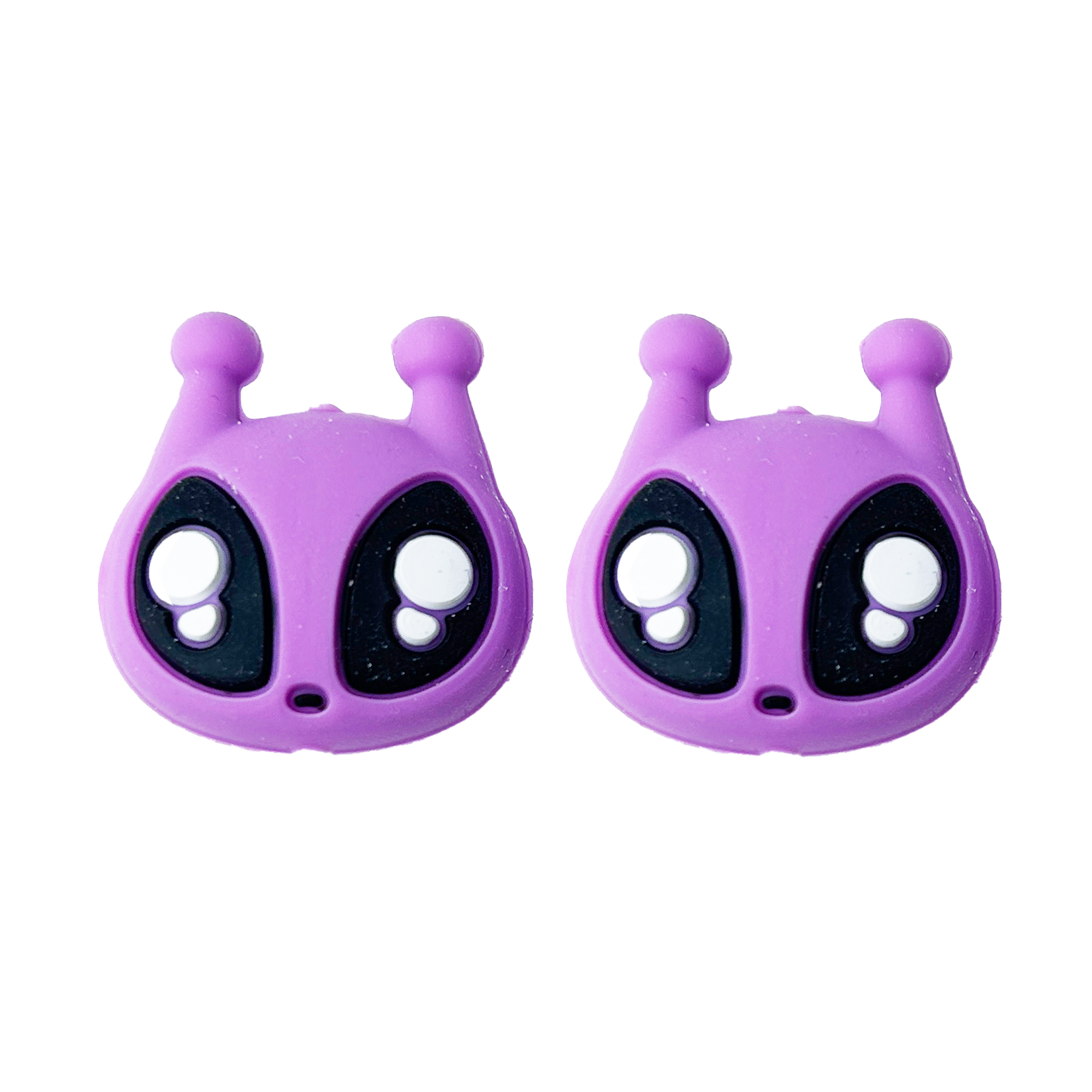 Two purple alien needle point protectors on a white background