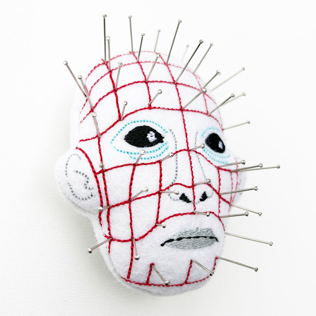 Pin head wrist pin cushion on a white background